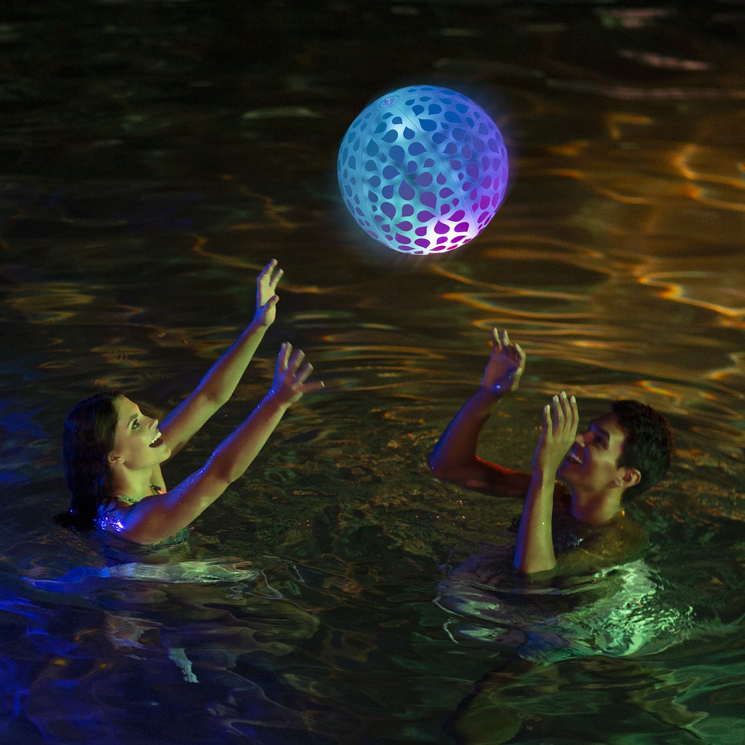 People playing with Funsicle FunGlow Ball in a pool at night