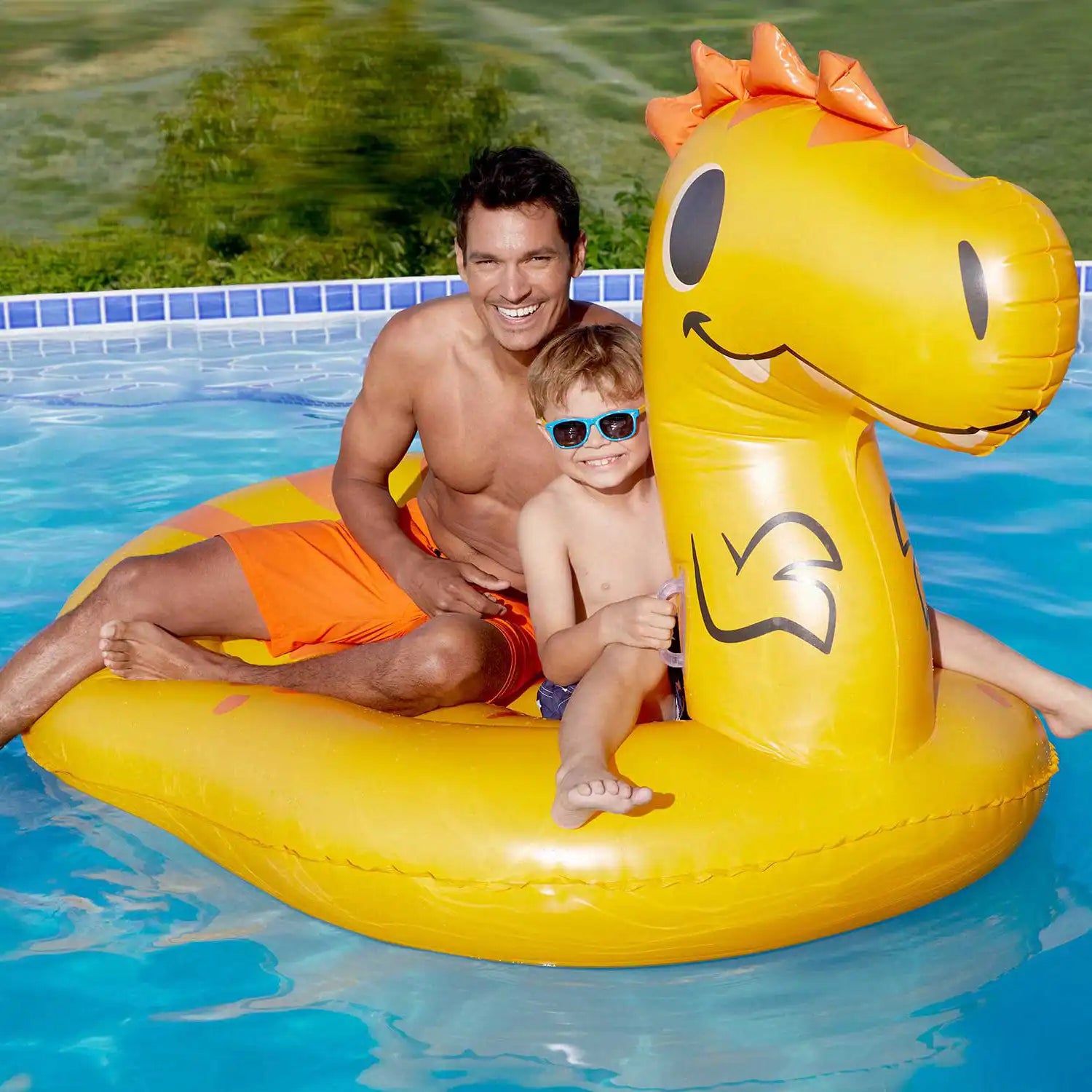models riding Funsicle DINOmite Ride-On in a pool