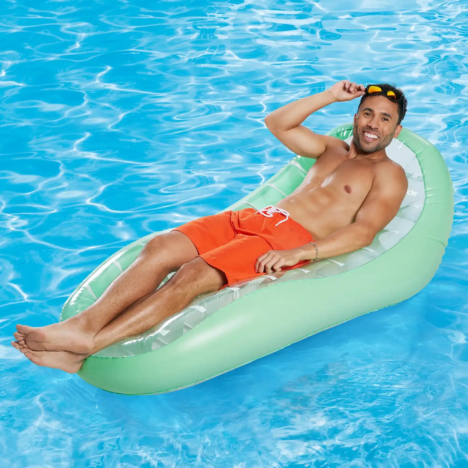 a model lounging on Funsicle BodyHug Lounge in a pool