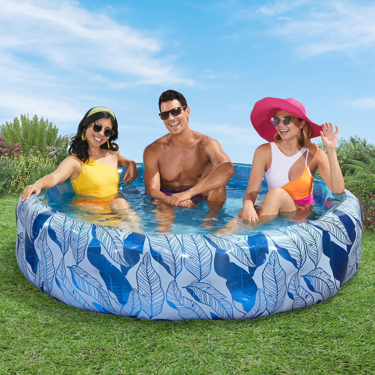3 people inside Funsicle Sapphire Tropics Funcuzzi Pool on grass field