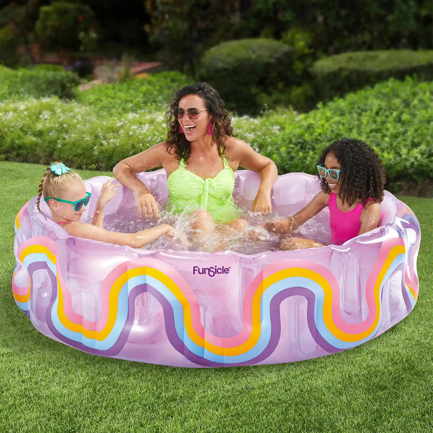 Mother watching over her kids playing inside Funsicle Wavy Rainbow Funcuzzi Pool on grass field
