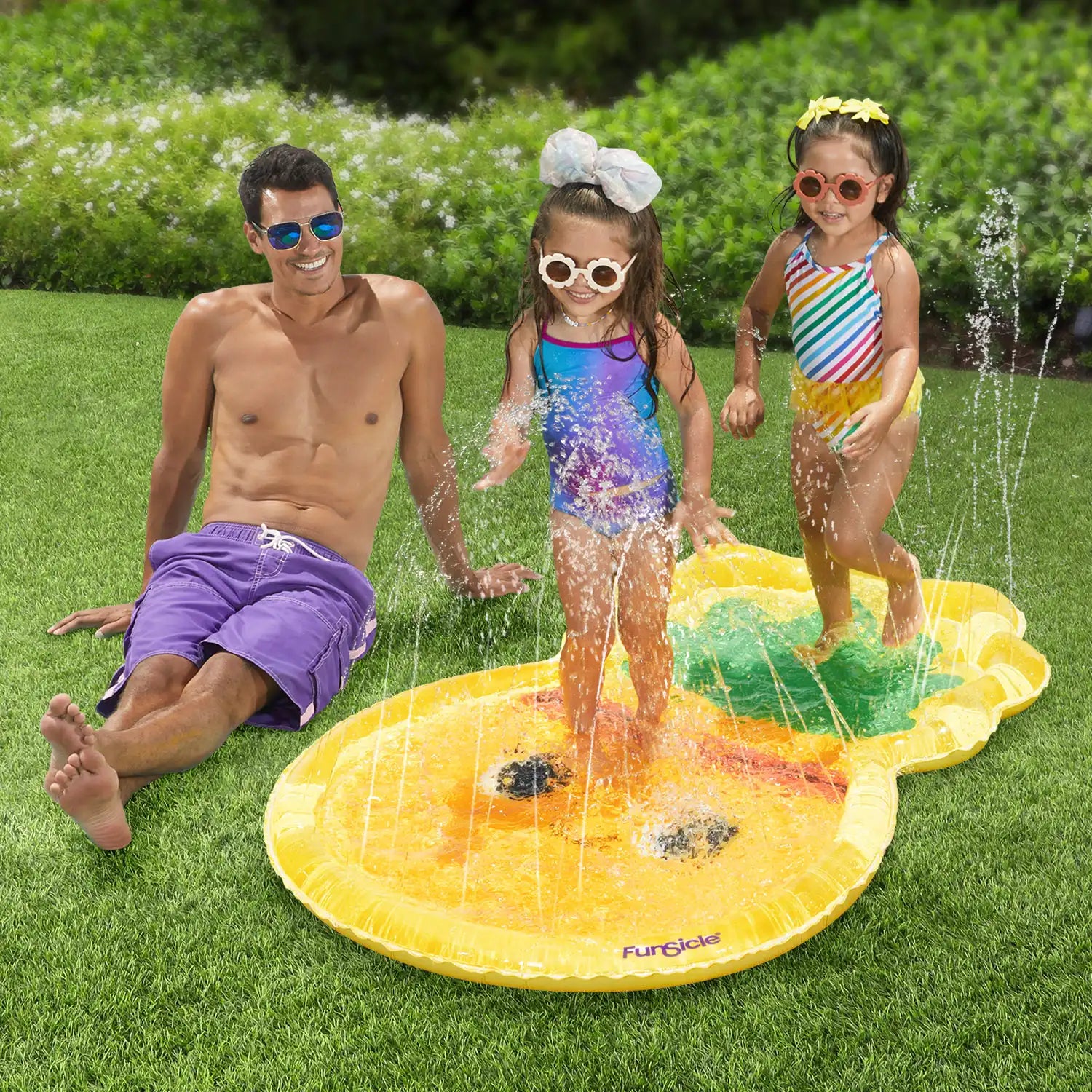 models with Funsicle Pineapple FunSpray Splash Mat in a garden
