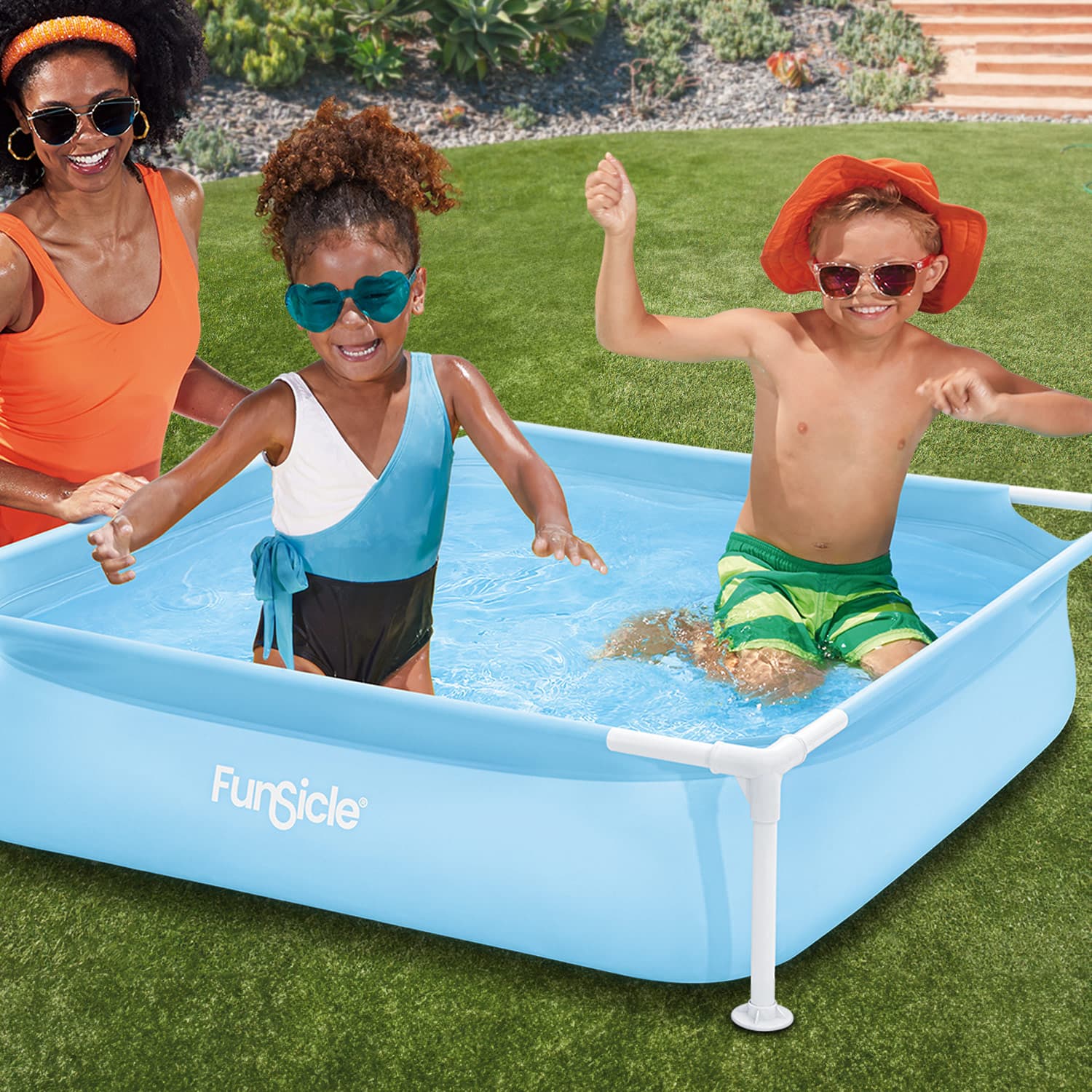Funsicle 4ft Kids Fun Pool with kids swimming in it and with an adult next to it on a grass background