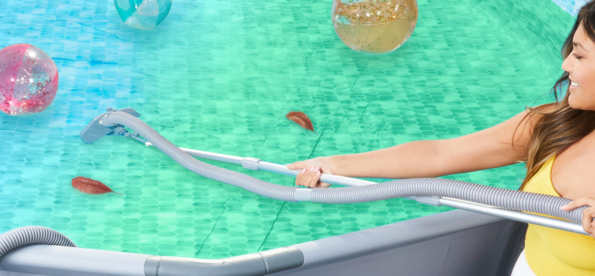 a woman vacuuming a greenish above ground pool