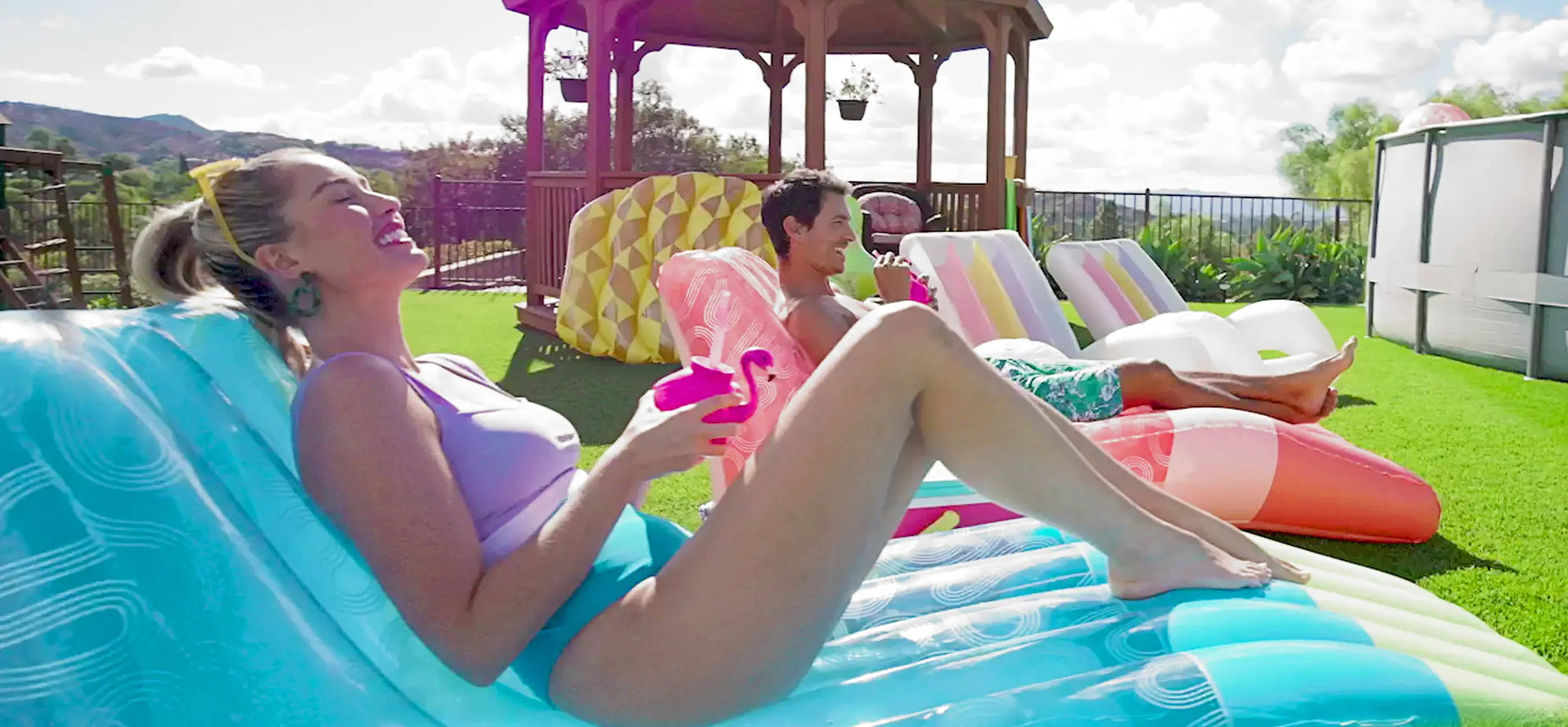 people lounging on inflatables at a backyard