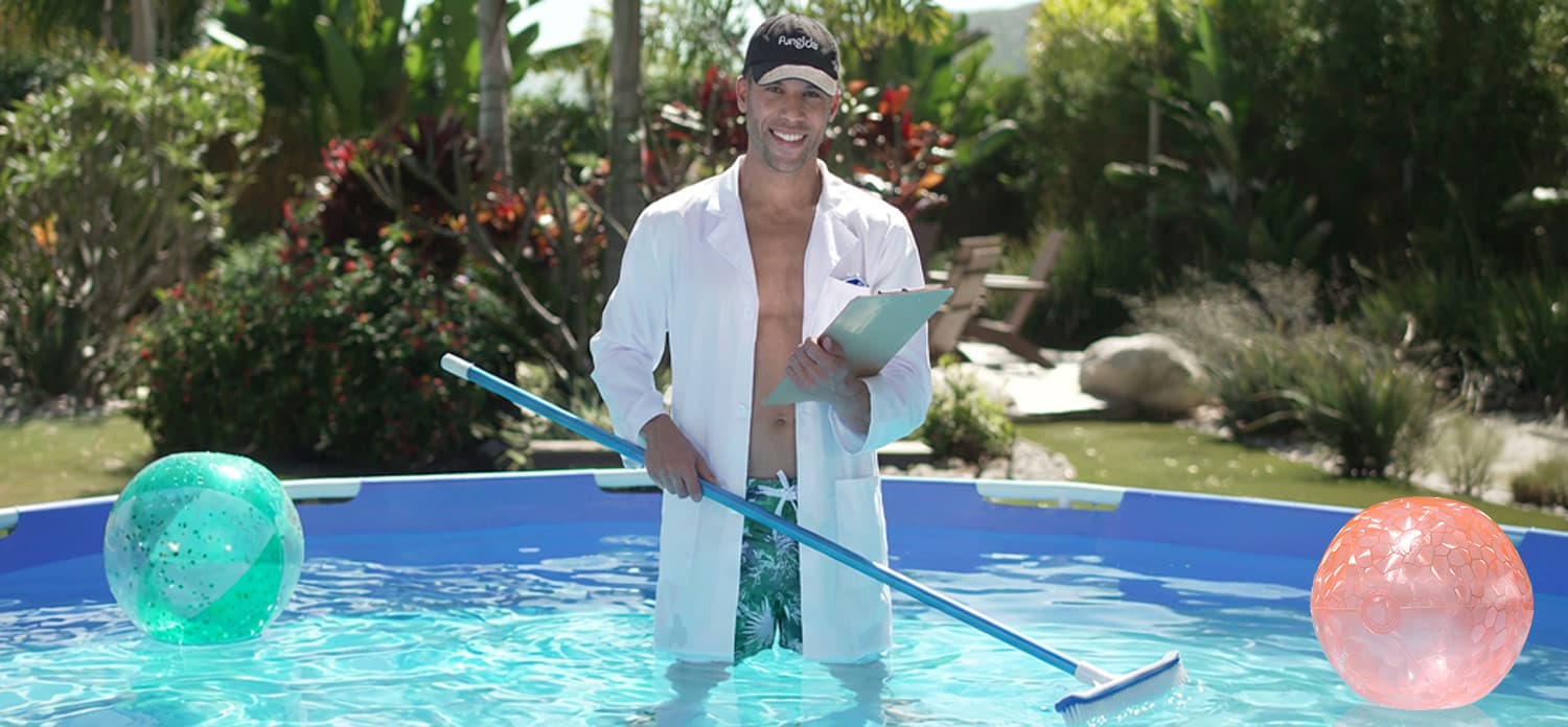 a man wearing white coat, holding a clipboard and pool brush standing in a swimming pool