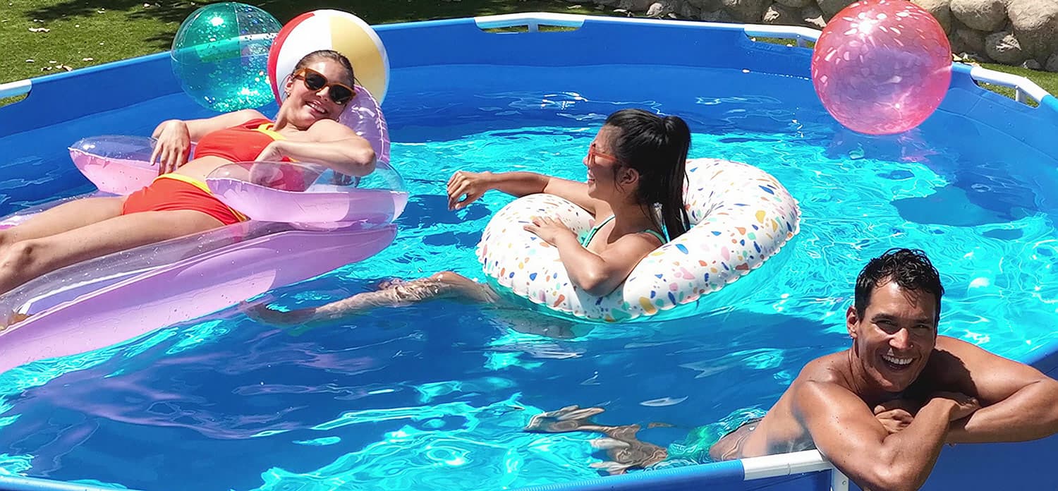 two women relaxing on inflatables inside a pool