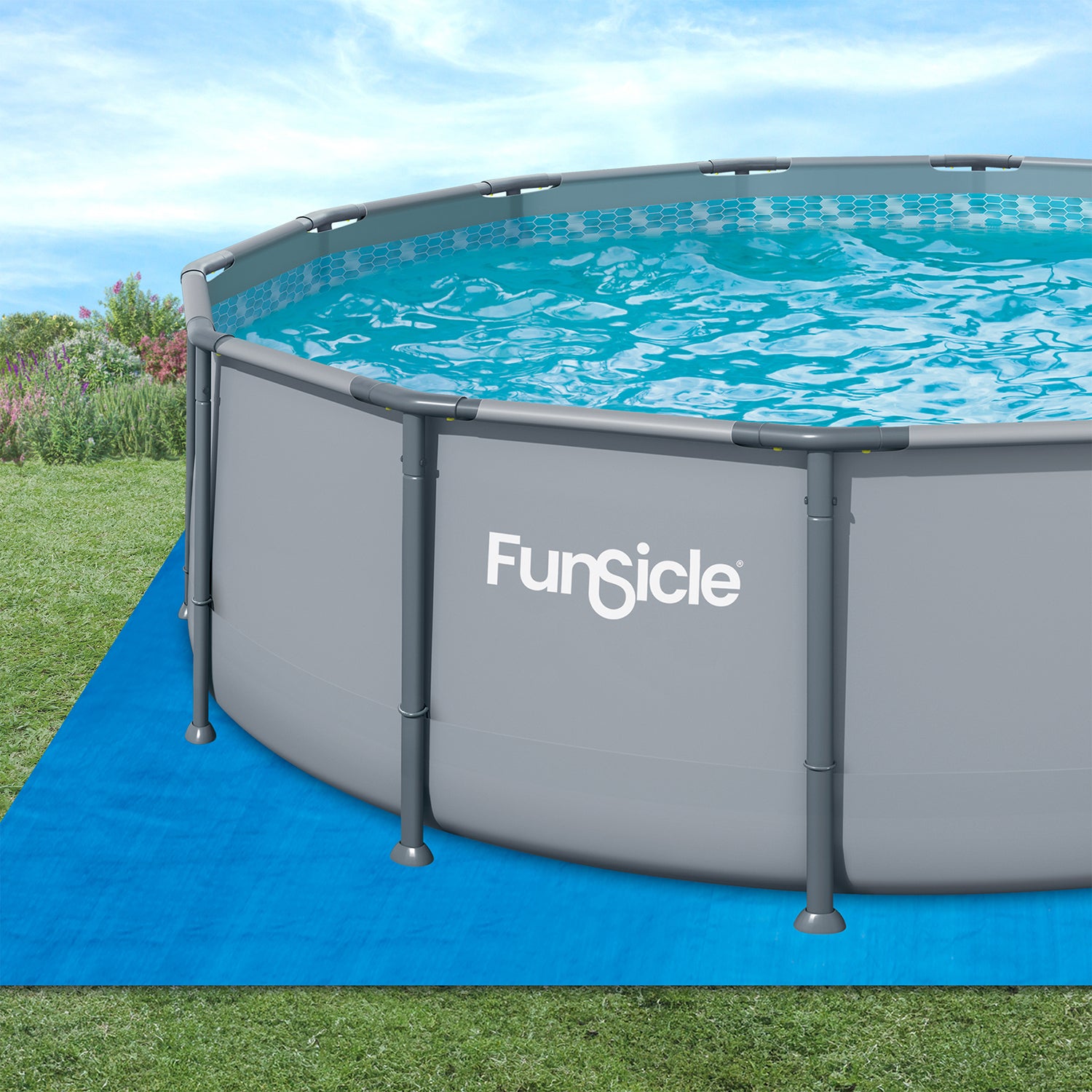 Funsicle above-ground pool on a blue ground cloth with grass and flowers in the background