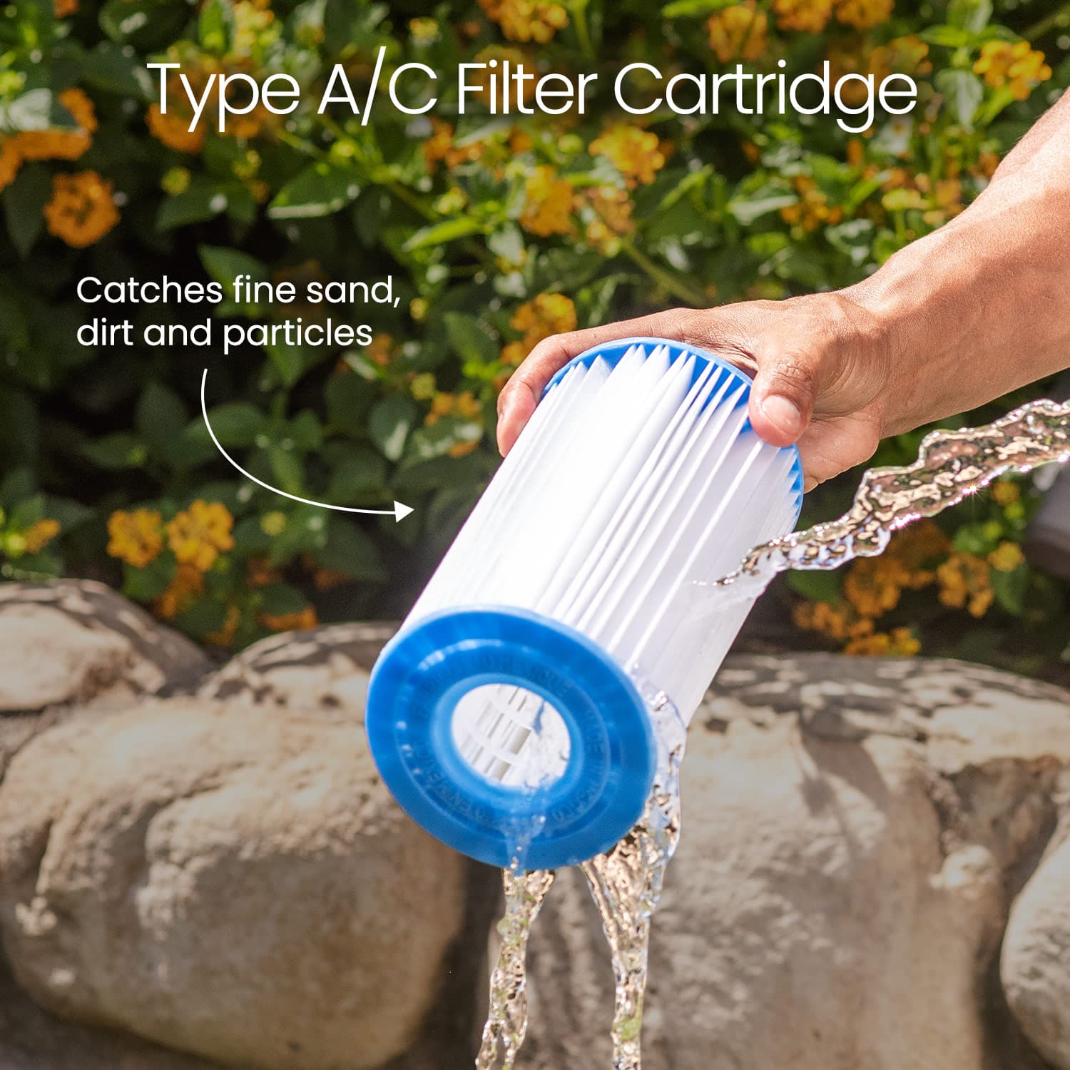Person holding a Type A/C Filter Cartridge with water flowing out, against a natural background.