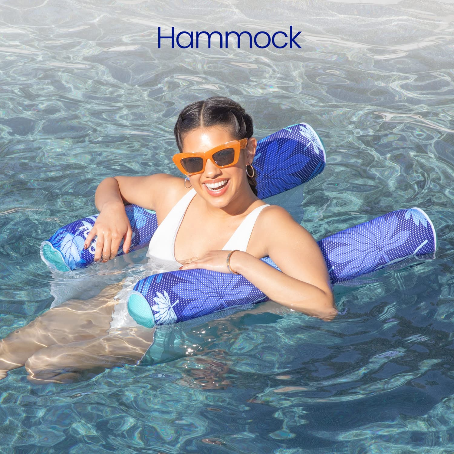 Woman lounging on a blue inflatable hammock in a pool