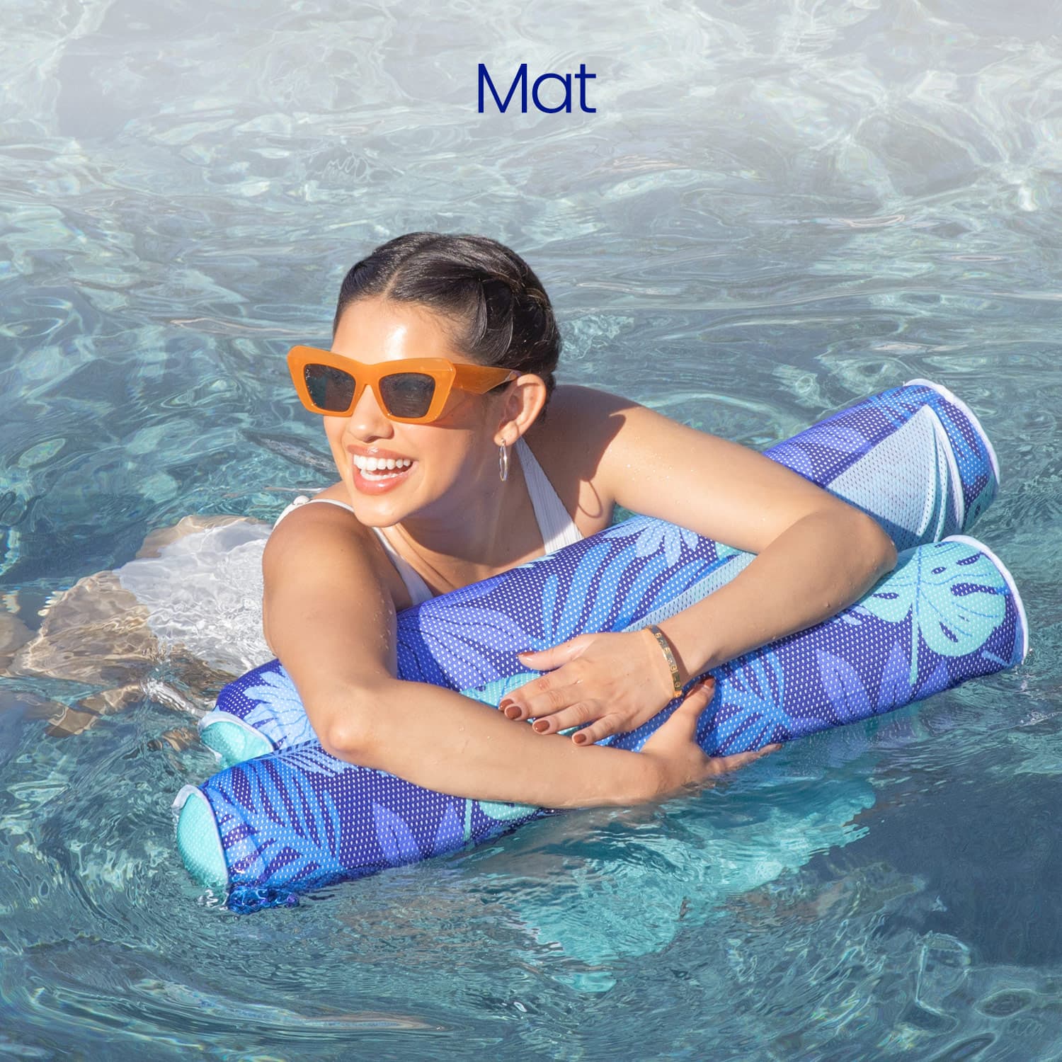 Woman lying on a blue and green hammock lounge in a pool