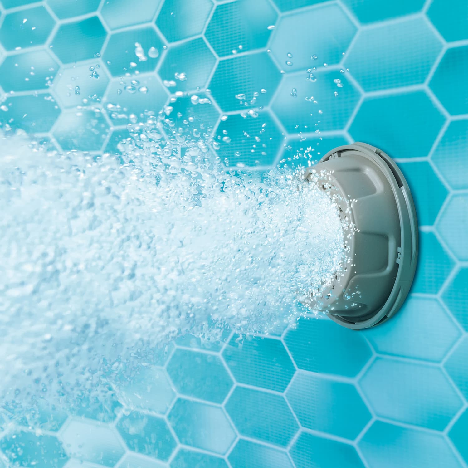 Pool skimmer with floating foam on a blue tiled pool surface