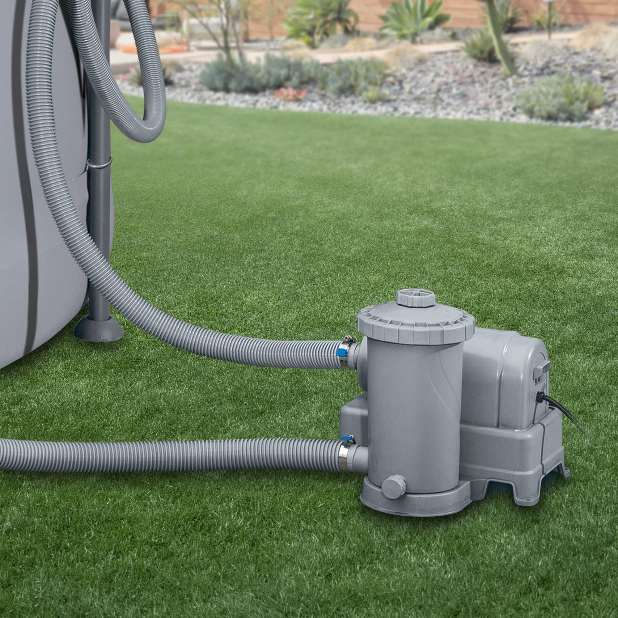 Pool pump with hose on grass