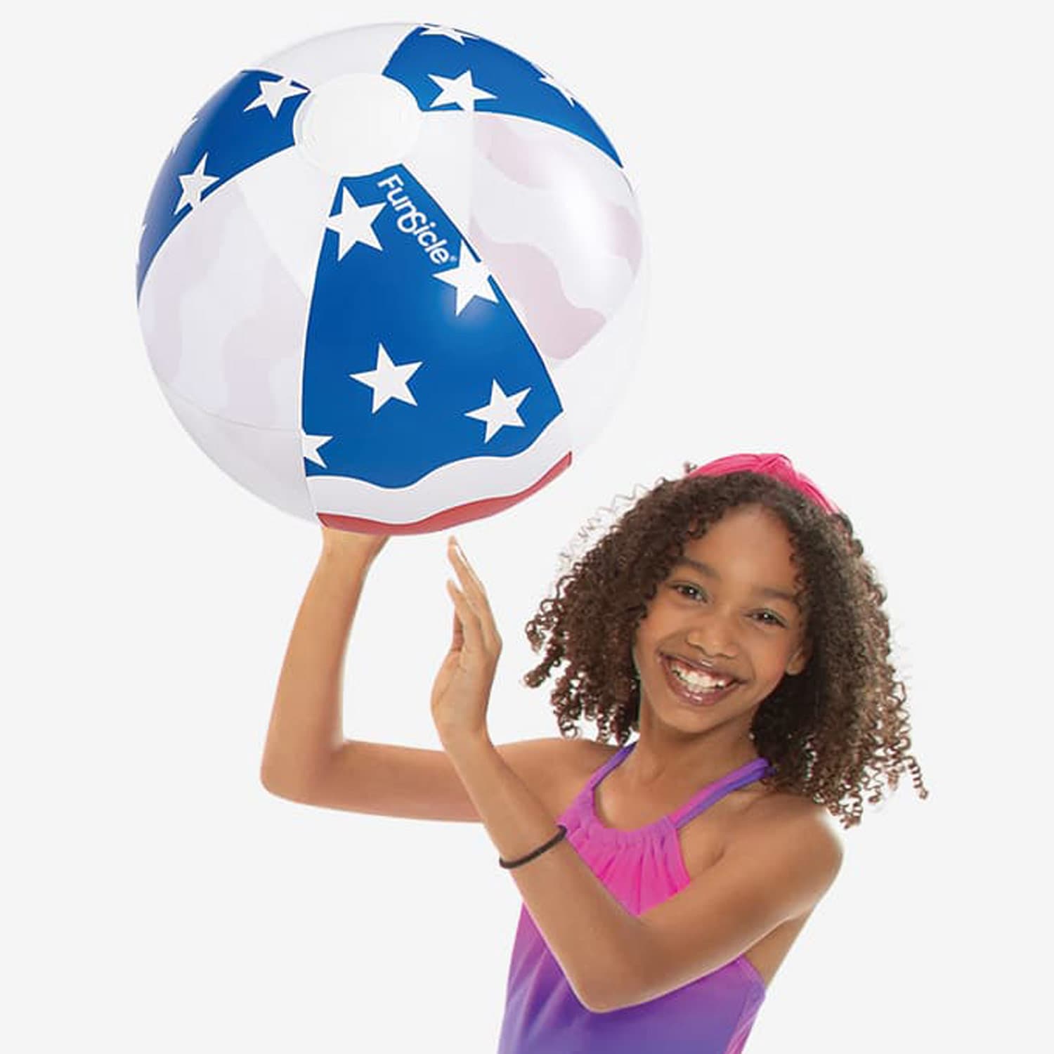 Girl holding a beach ball with American flag design on a white background