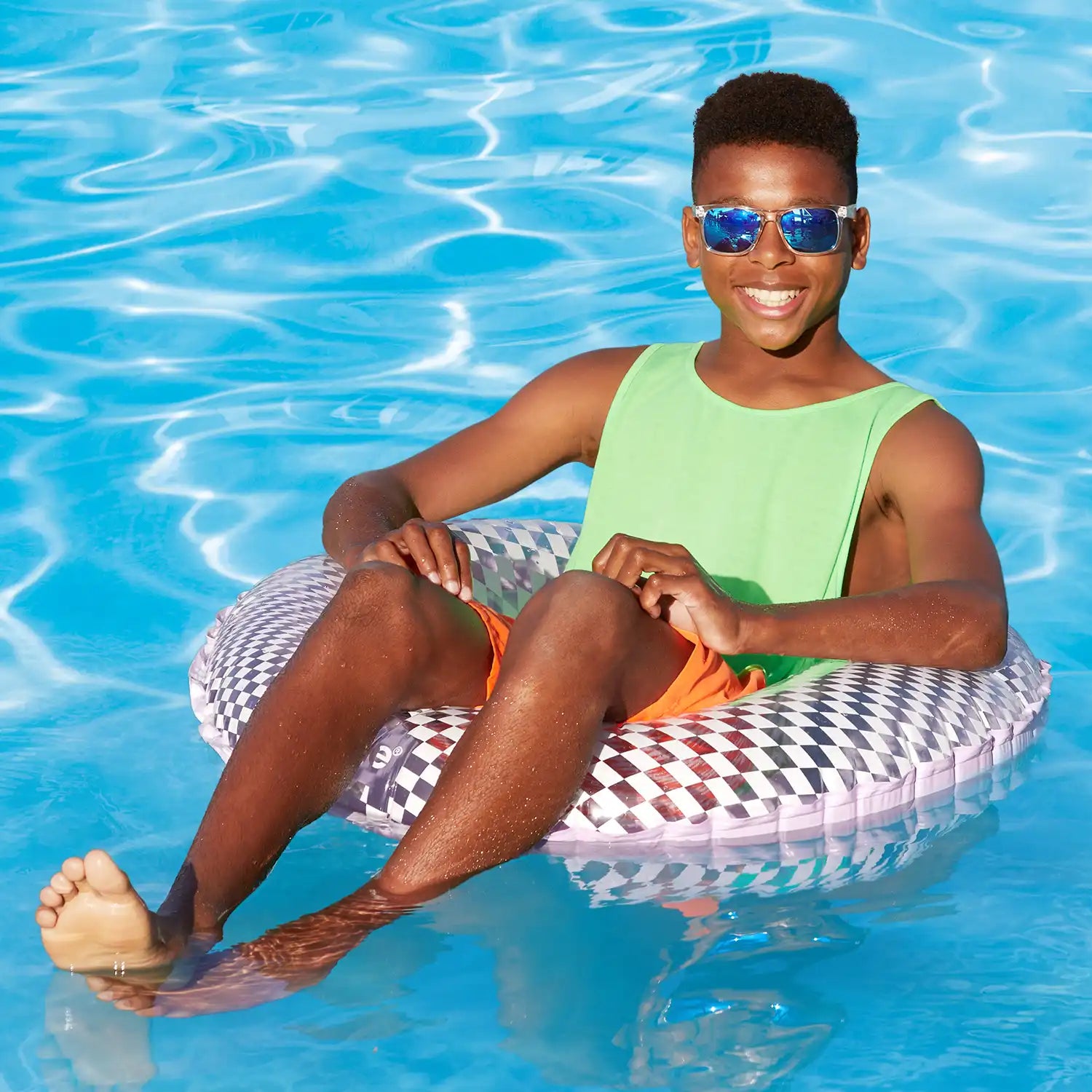a model lounging on Funsicle Checkered FunTube in a. pool