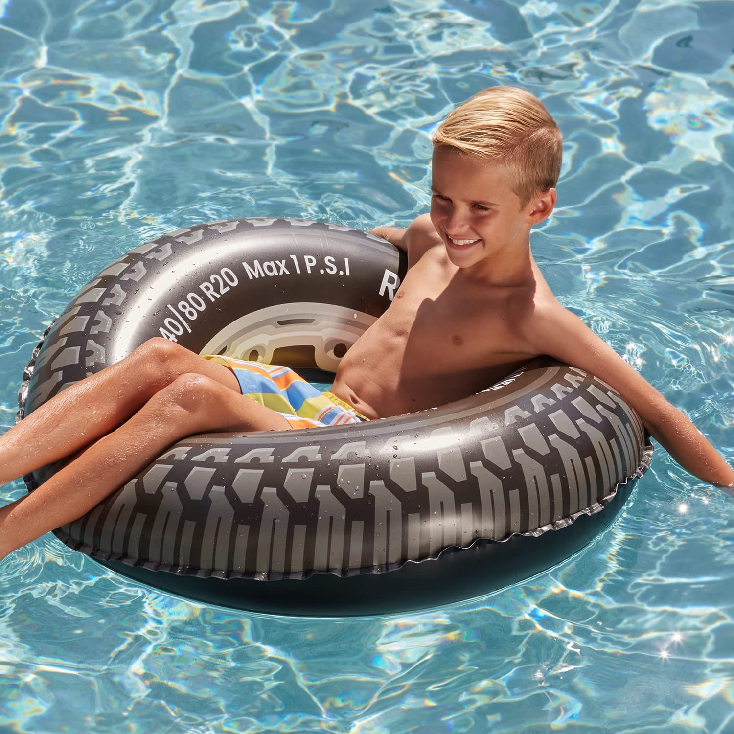 Funsicle Rollin’ Tire FunTube with a model lounging on it in water