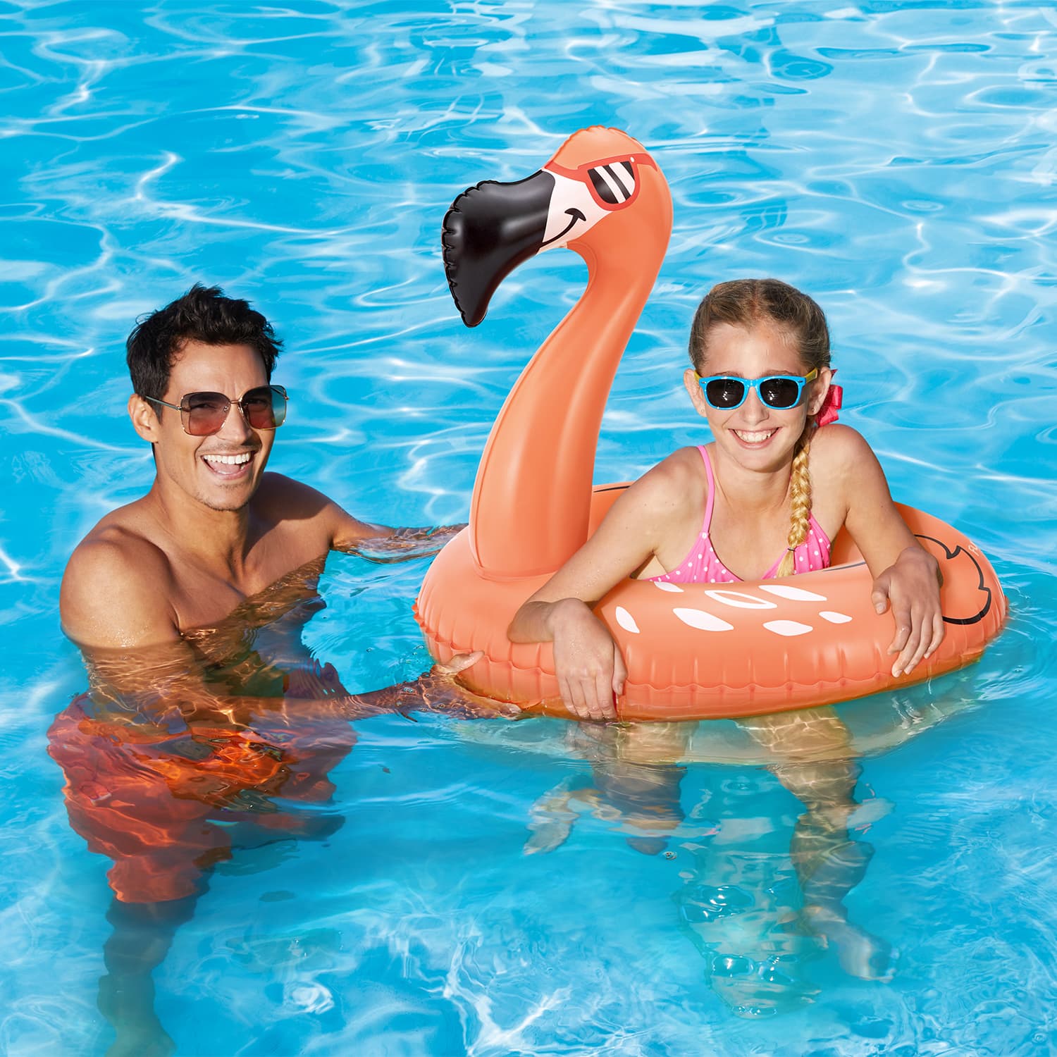 Funsicle Flaming Flamingo FunRing with two models in a pool