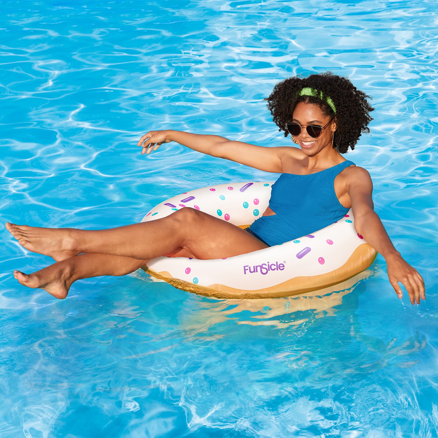 Funsicle Iced Donut FunTube with a model lounging in a pool