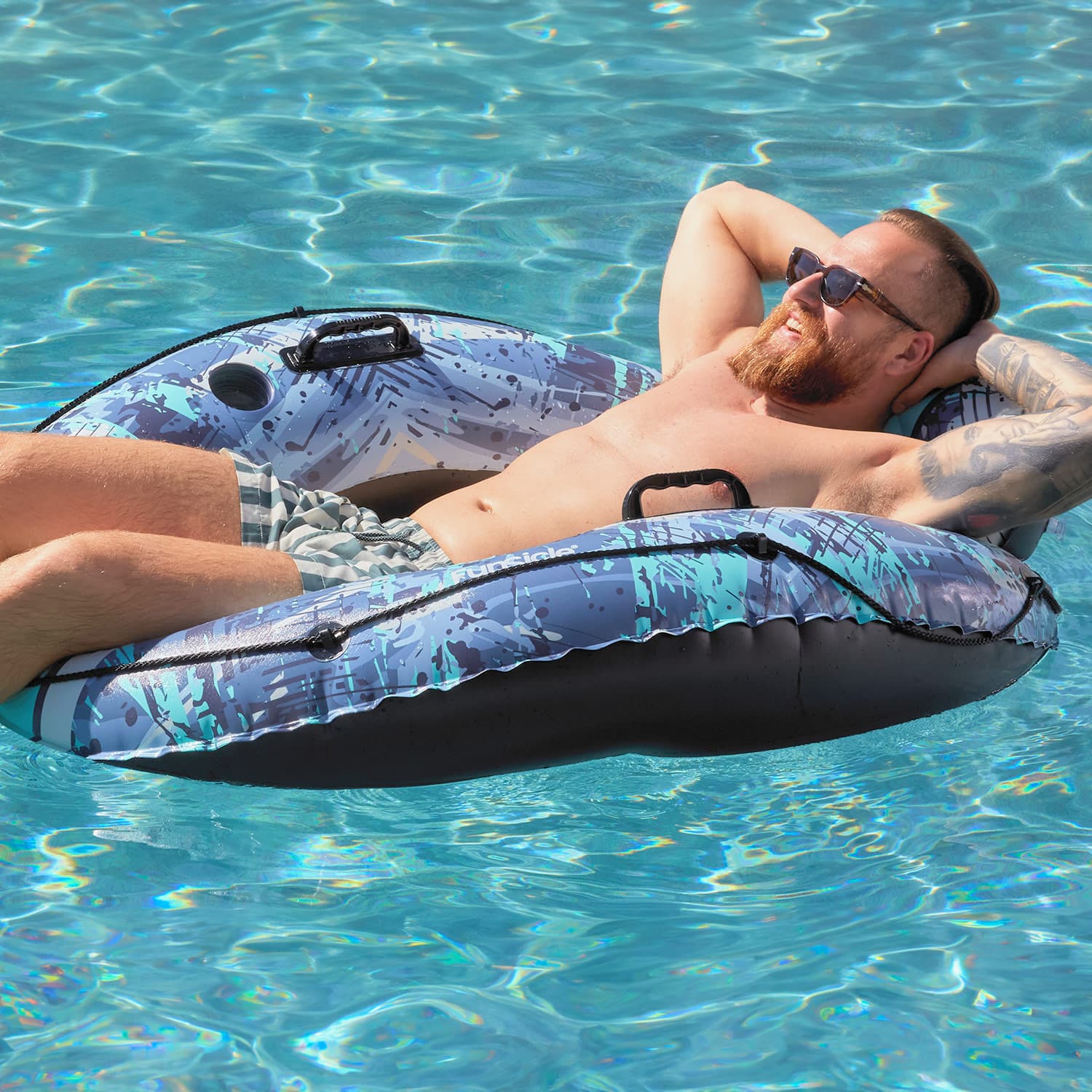 Funsicle Sierra Blue Lounge with a person lounging on it in a pool