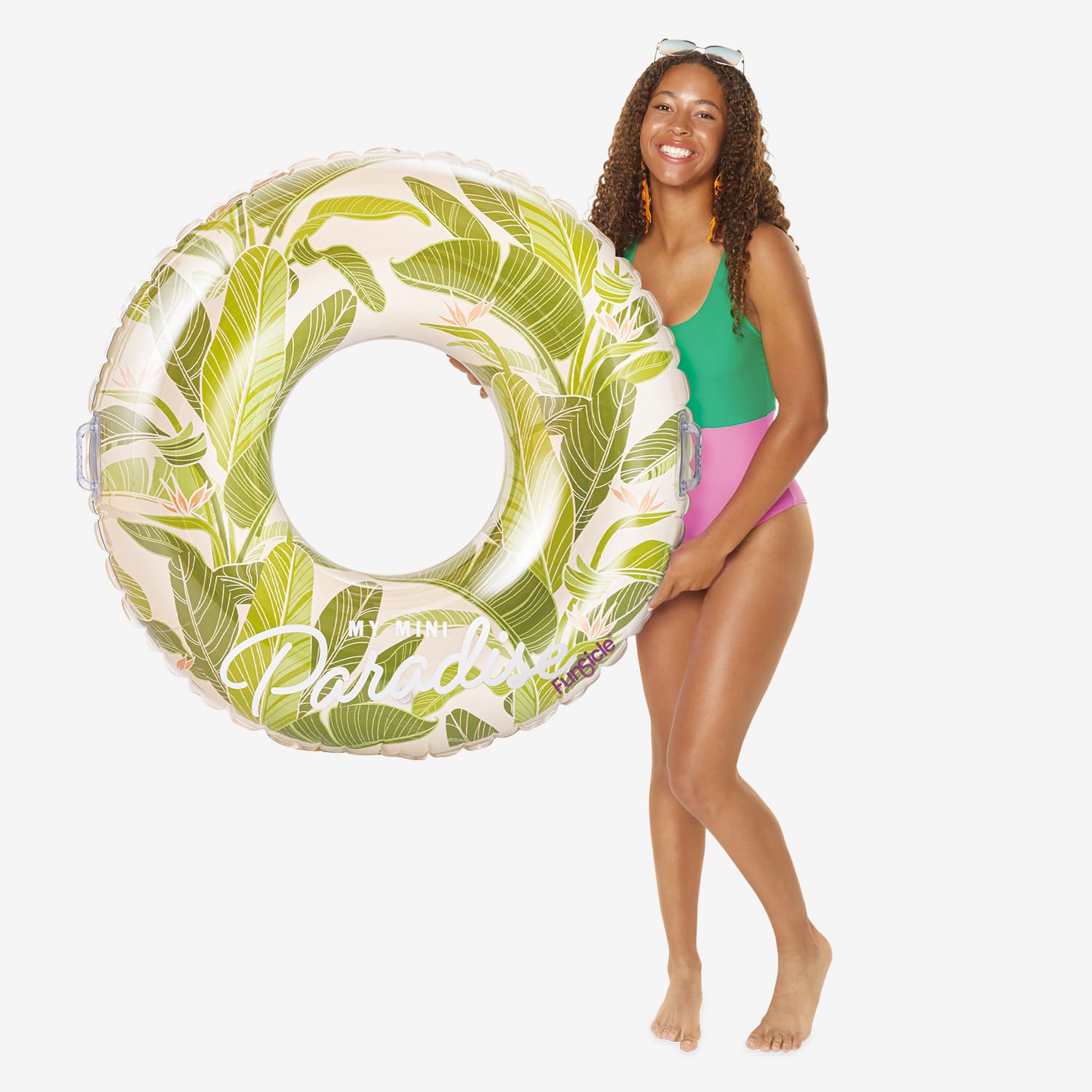 Woman holding a leaf-patterned inflatable ring on a white background