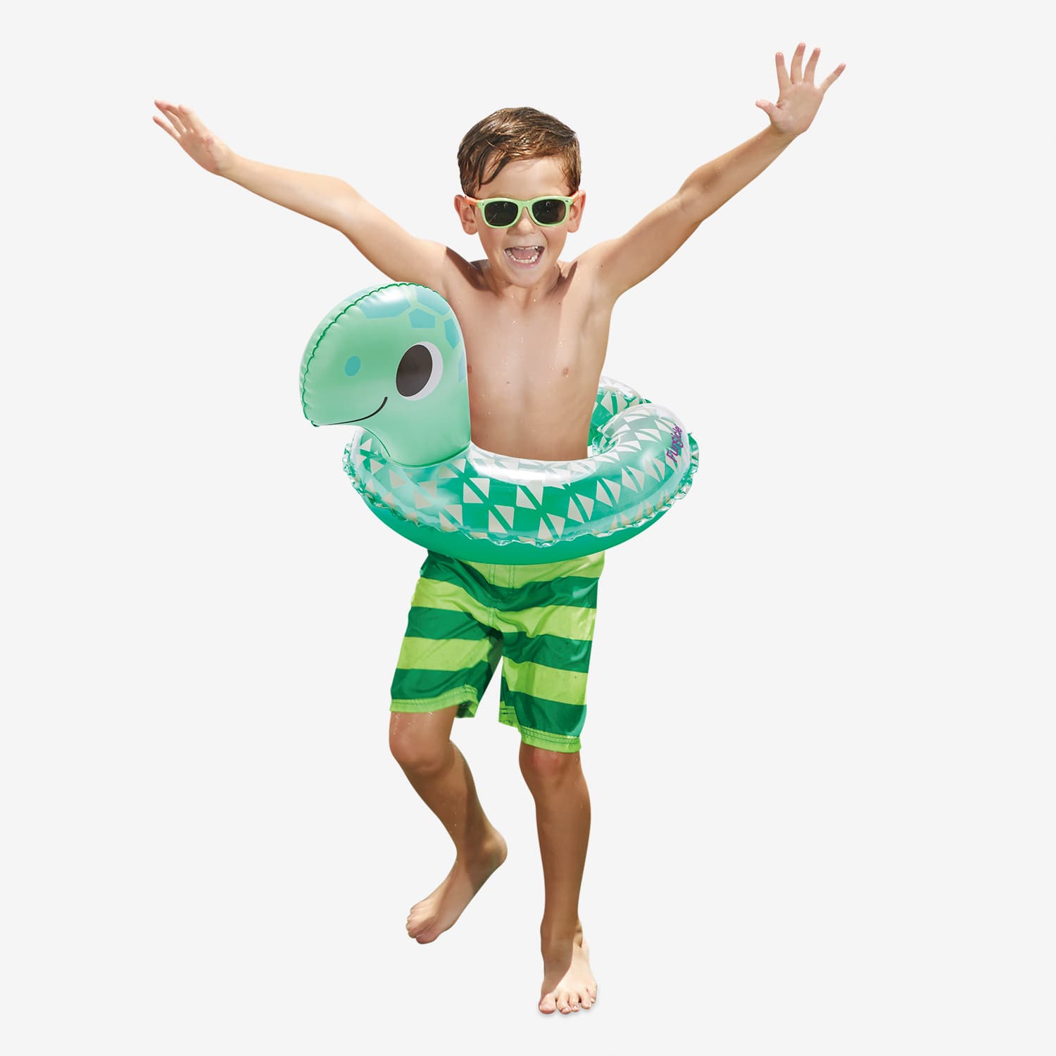 Child wearing a green inflatable turtle float and striped swim shorts on a white background