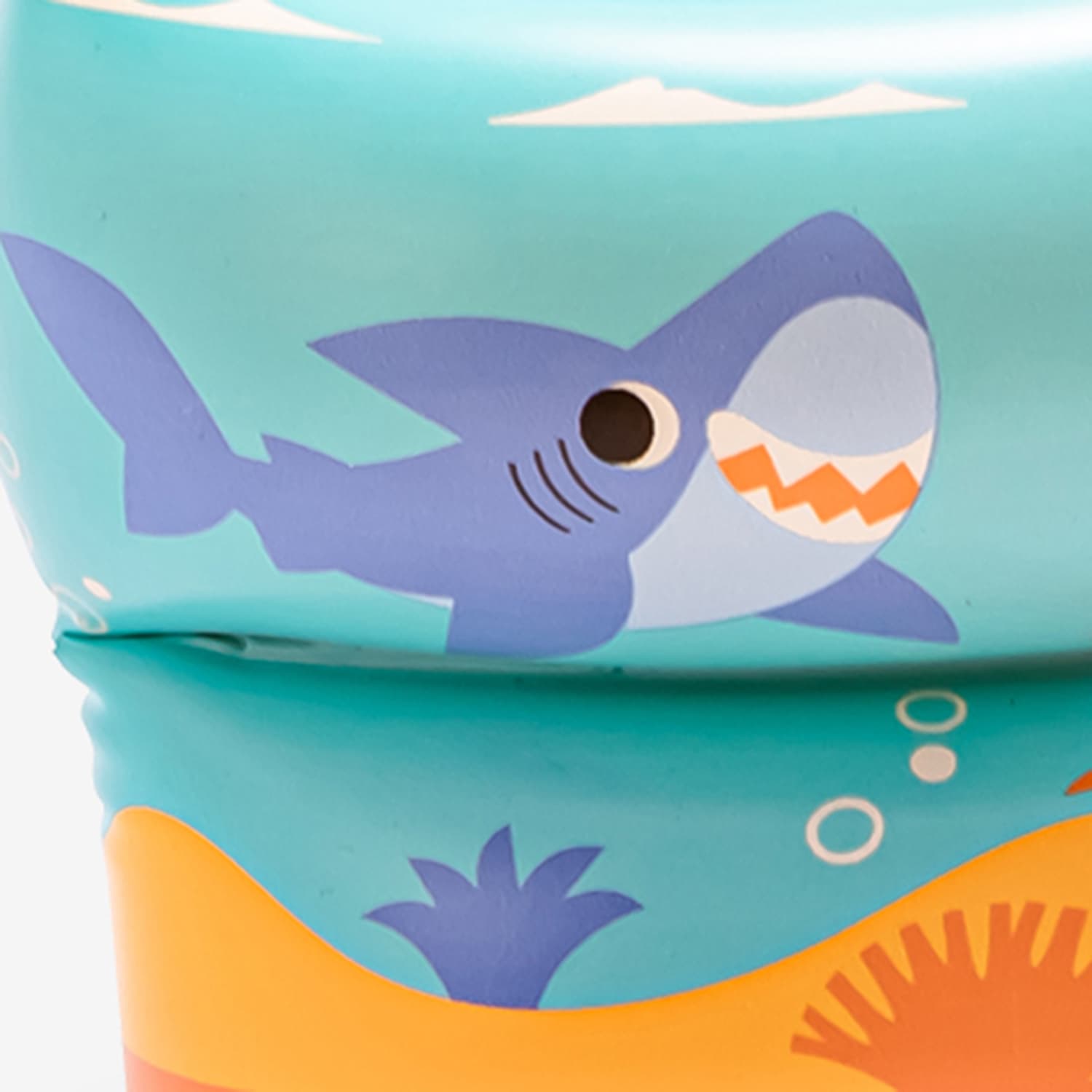Children's cup with shark design on a blue background