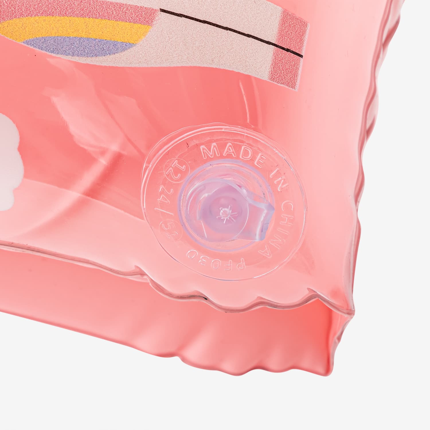 Close-up of a pink product packaging with a brand logo on a white background