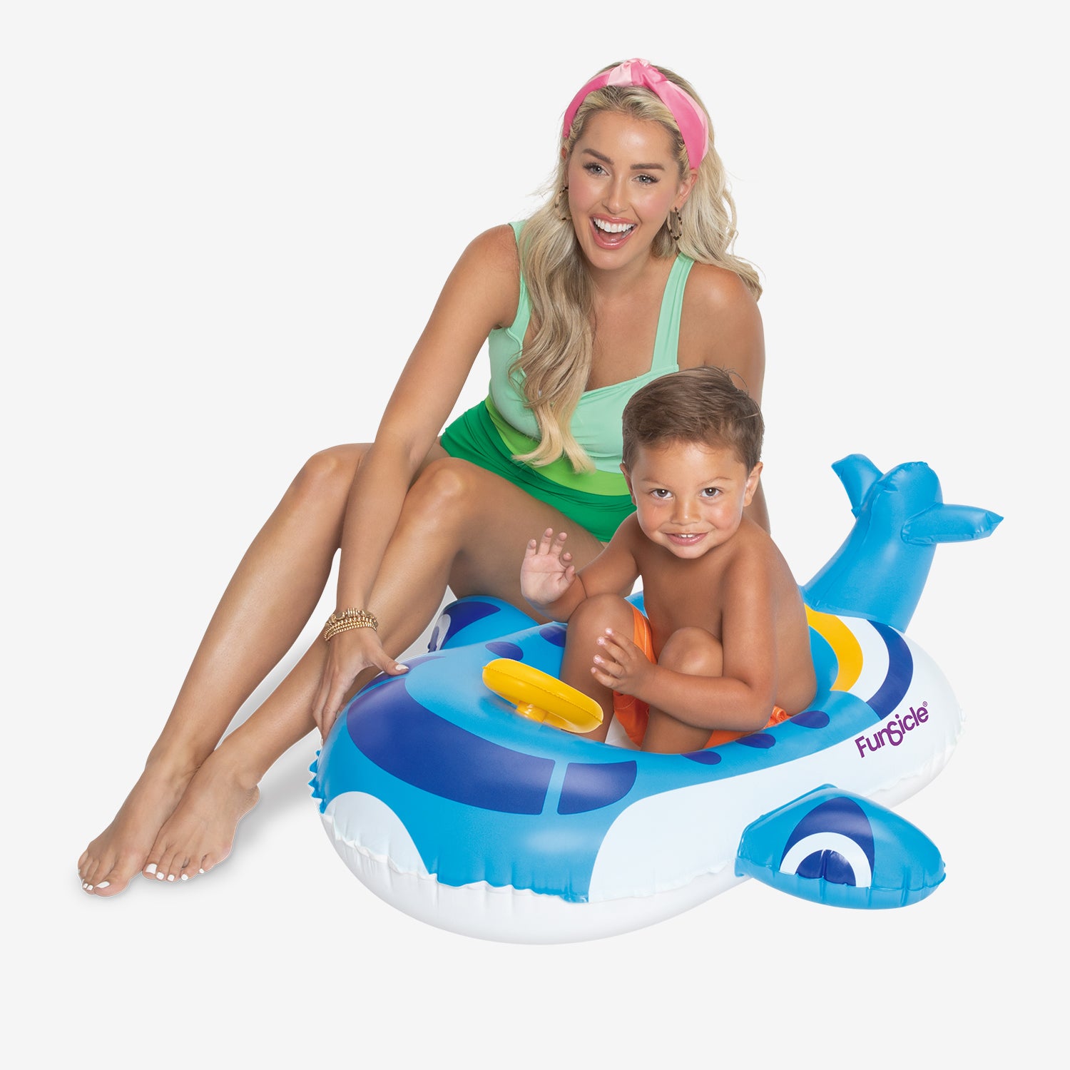 Woman and child sitting on a blue inflatable airplane-shaped pool float against a white background