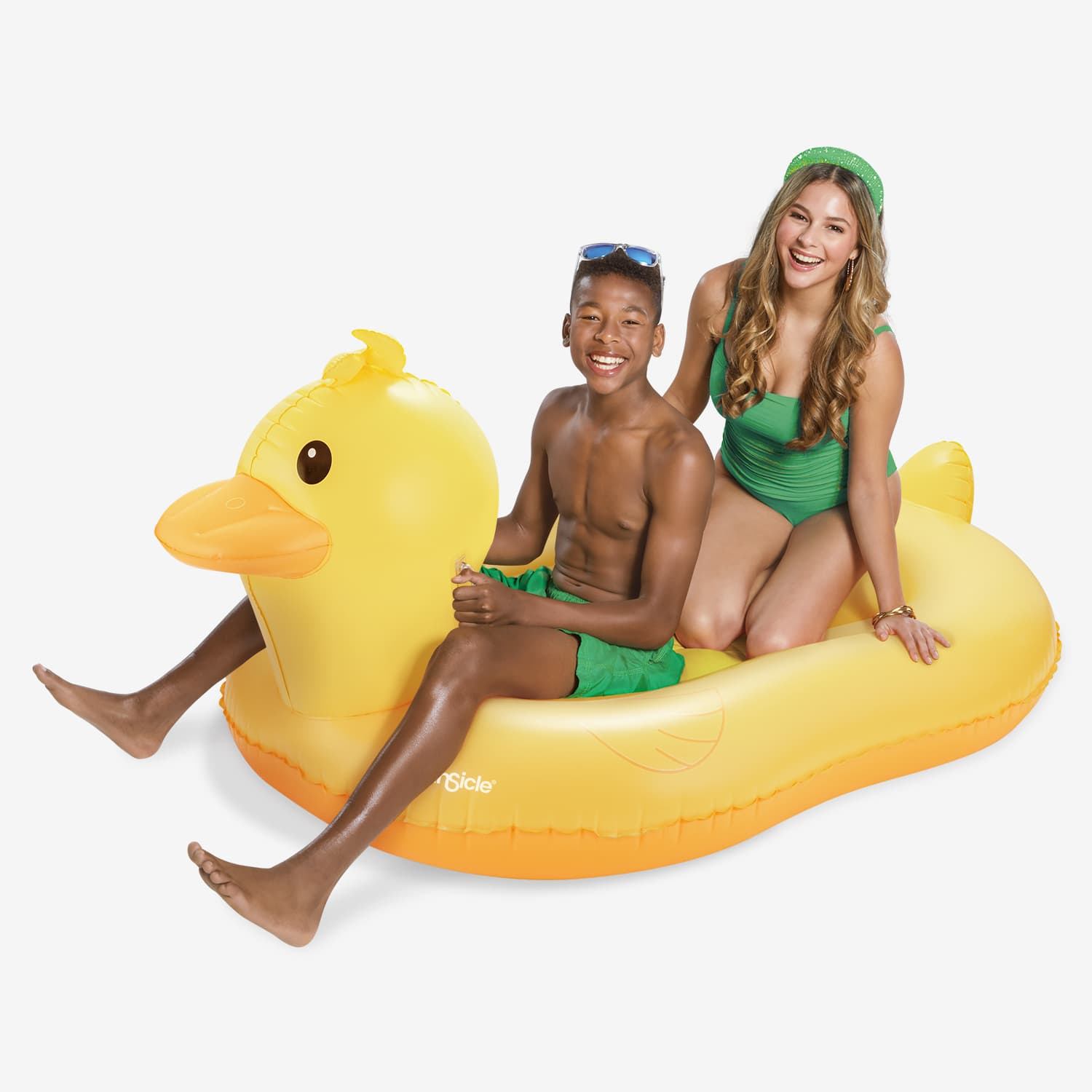Two people sitting on a yellow inflatable duck pool float against a white background