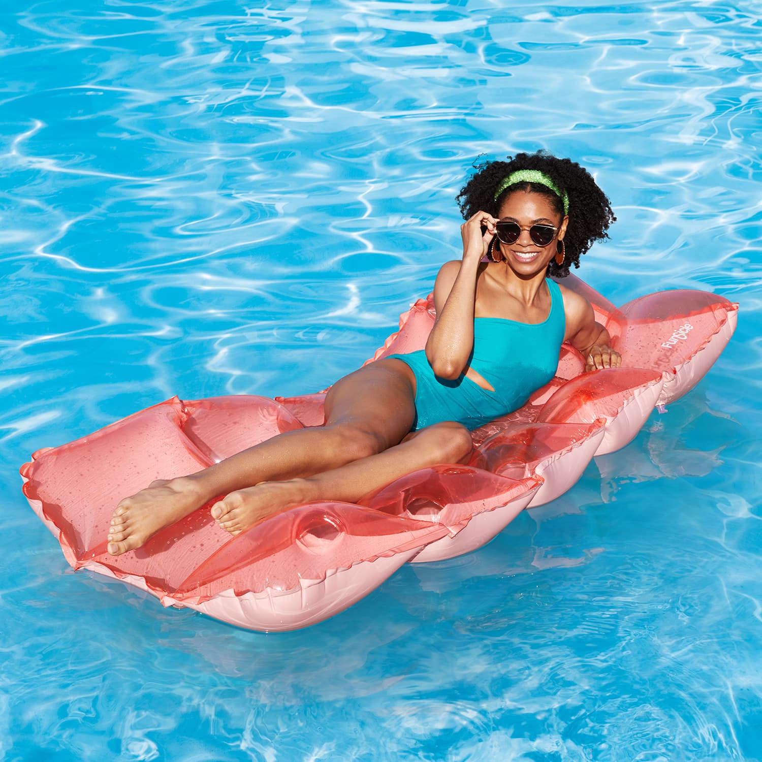 a model lounging on Funsicle Cloud Escape Mat in water