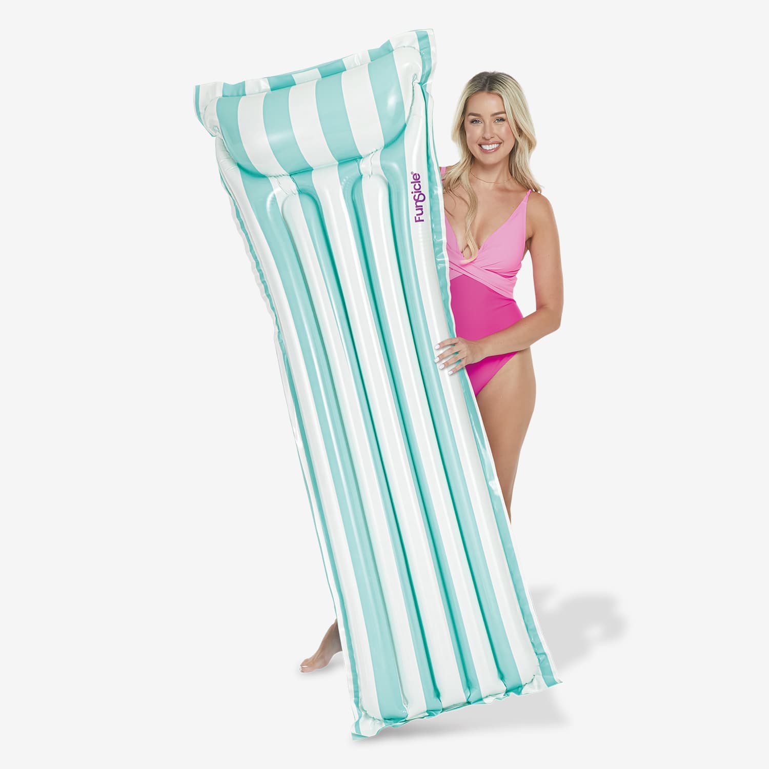 Woman holding a striped inflatable pool float against a white background