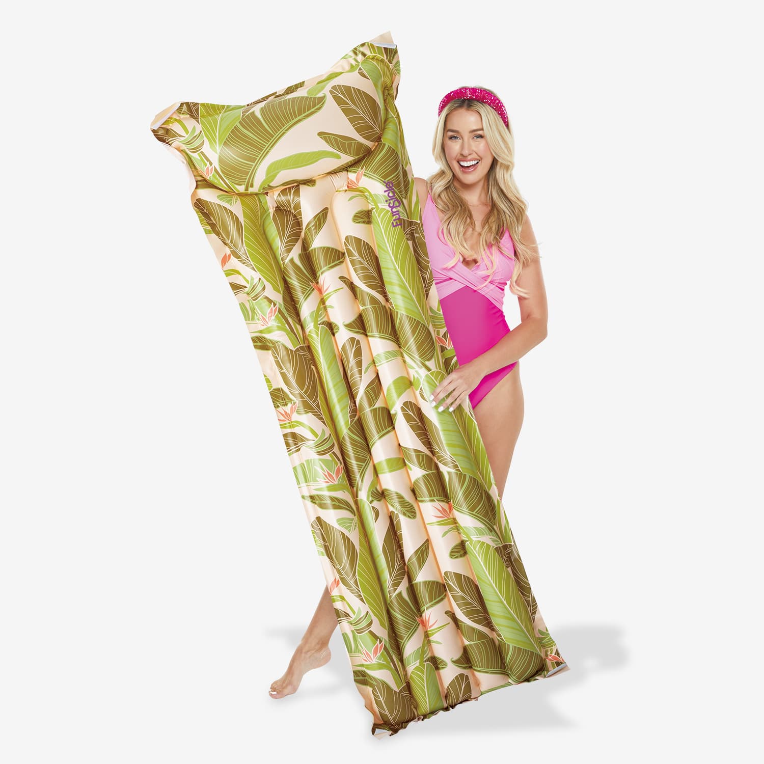 Woman holding a large green leaf-patterned pool float with a pink swimsuit on a white background