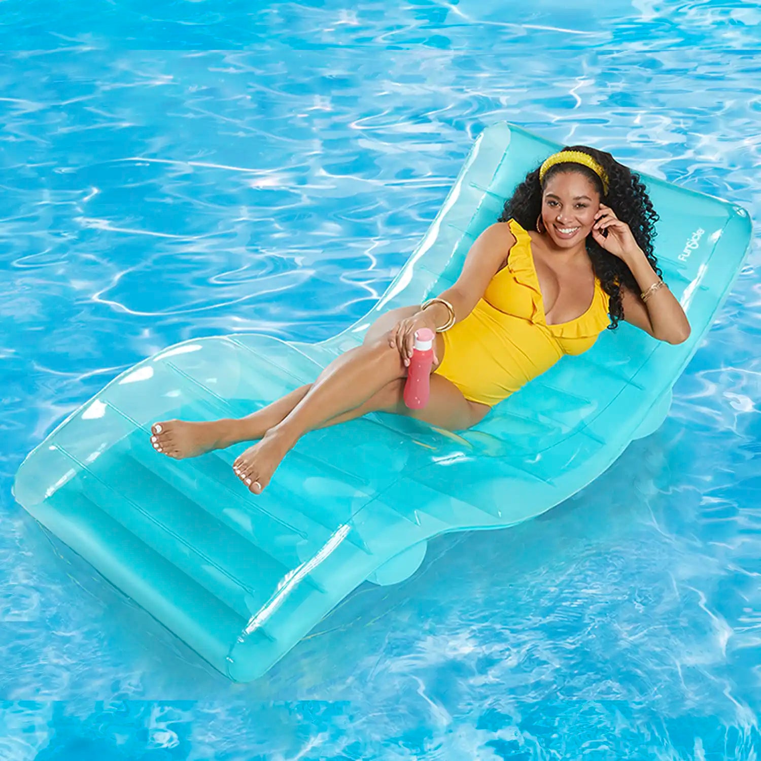 a model lounging on Funsicle SunChaiser Lounge in a pool