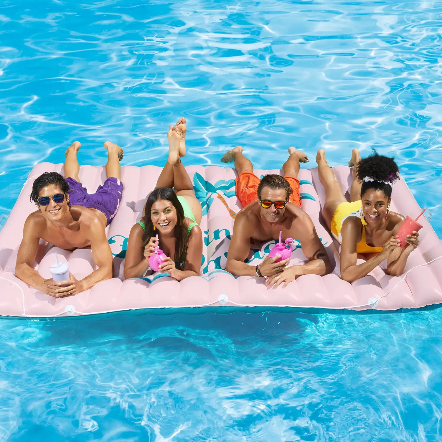 models lounging on Funsicle Float in Paradise Mat in a pool