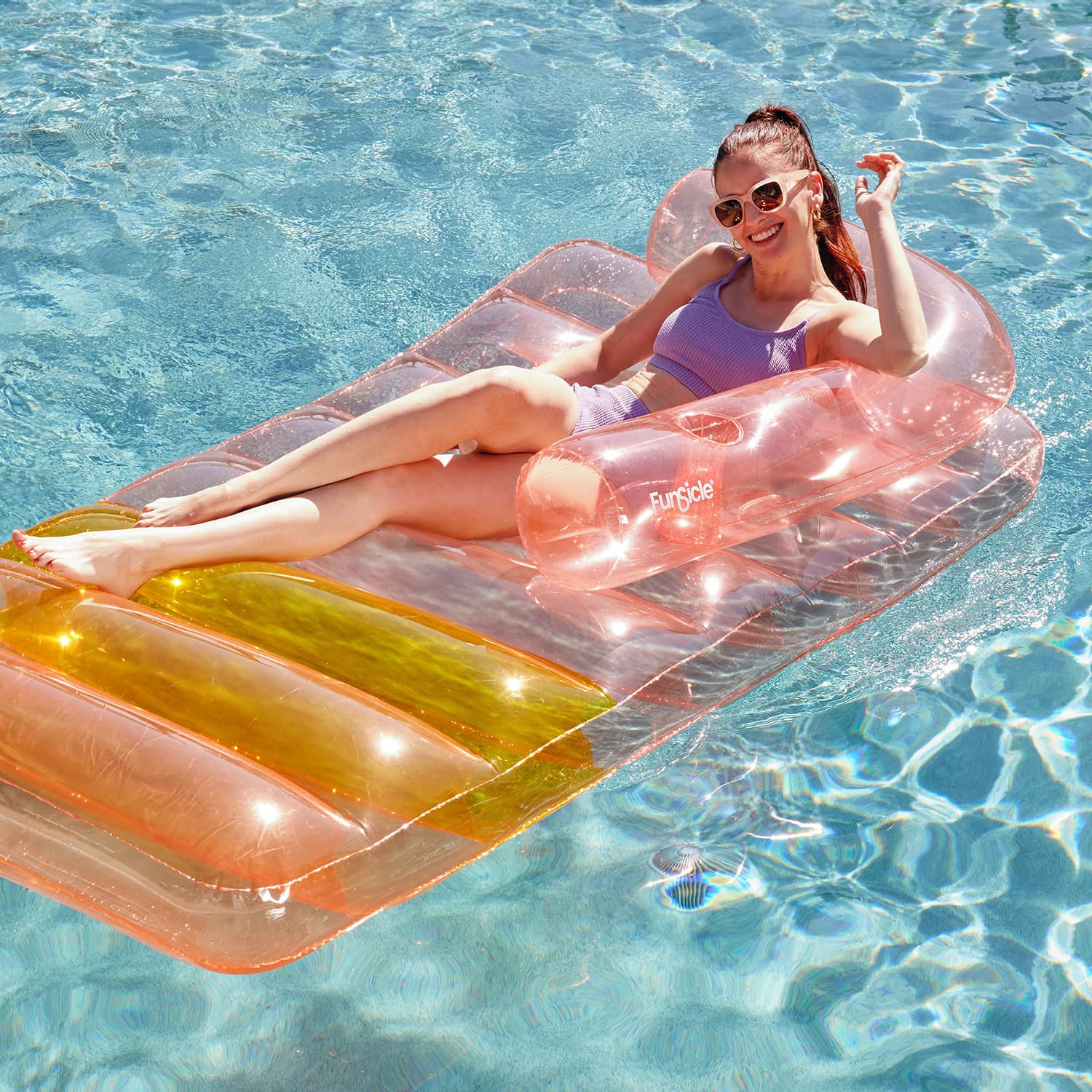 Funsicle Sofa Bed Lounge with a model lounging on it in a pool