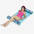 Woman in pink swimsuit sitting on a blue inflatable pool mat with tropical pattern