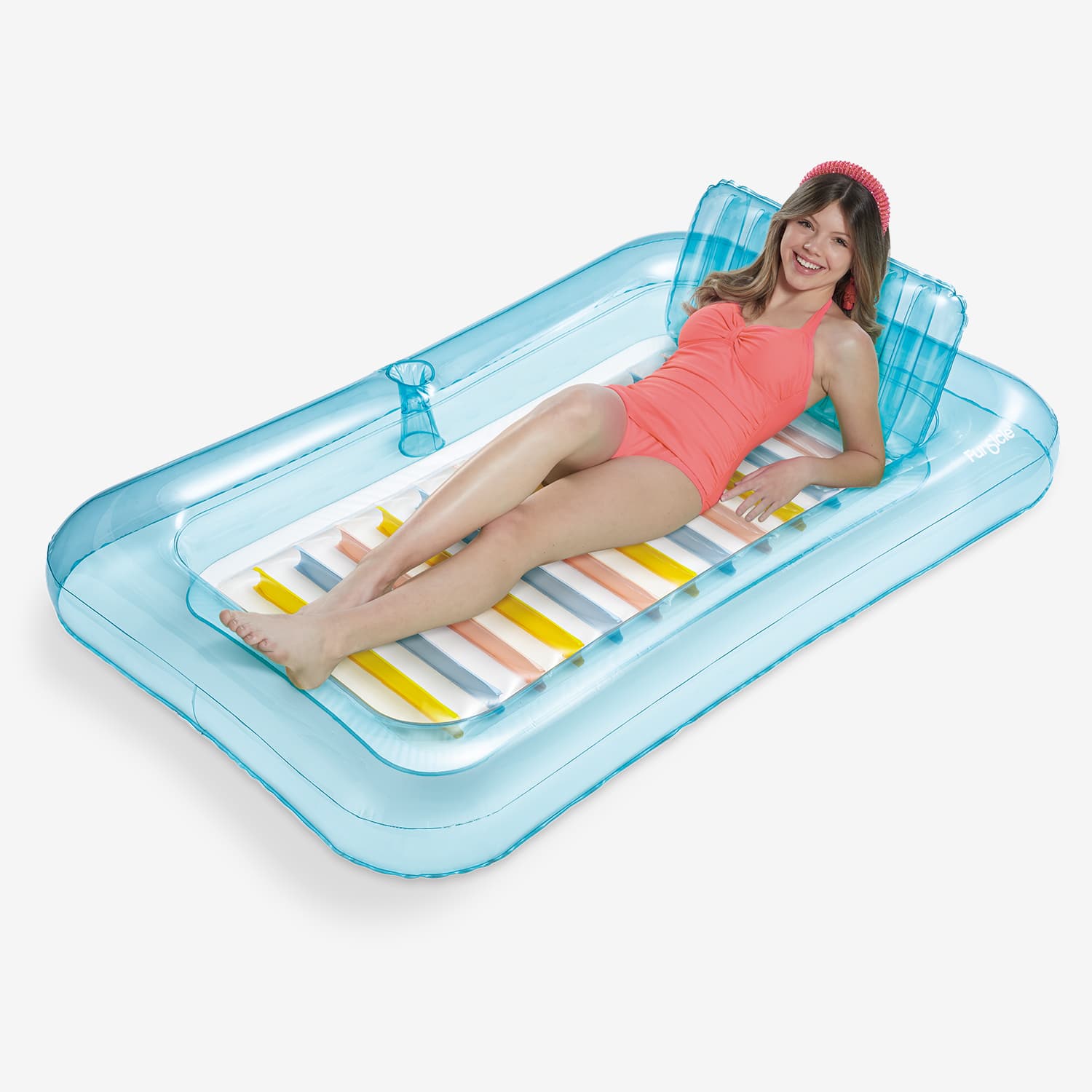 Woman lying on a large inflatable tub with a striped pattern.