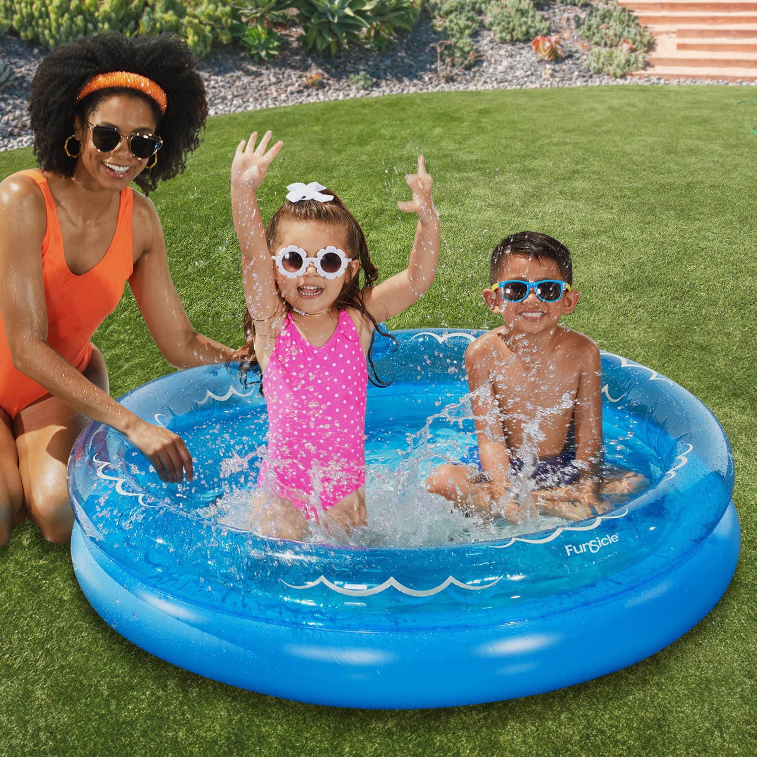 Funsicle Friendly Shark FunRing Pool with models on a grass background