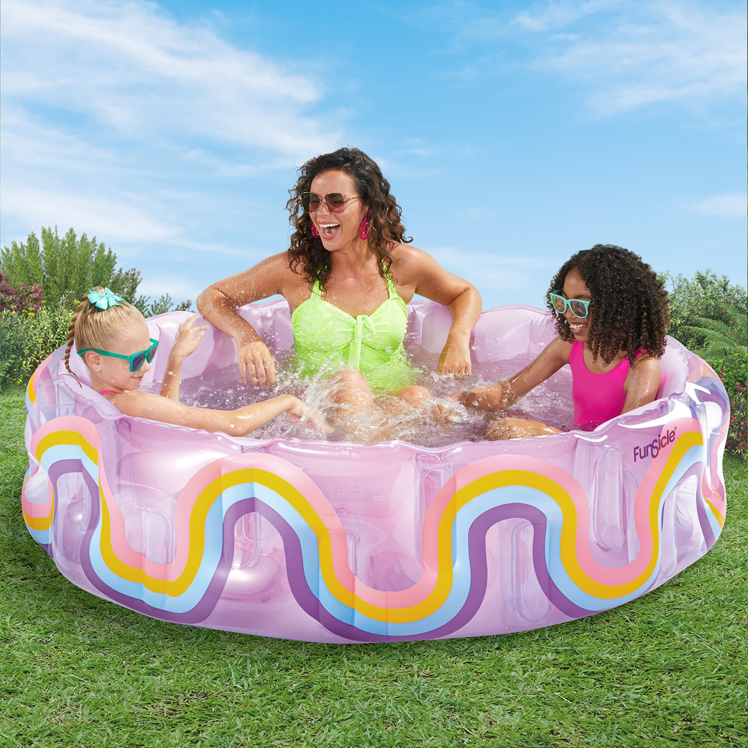 Mother watching over her kids playing inside Funsicle Wavy Rainbow Funcuzzi Pool on grass field