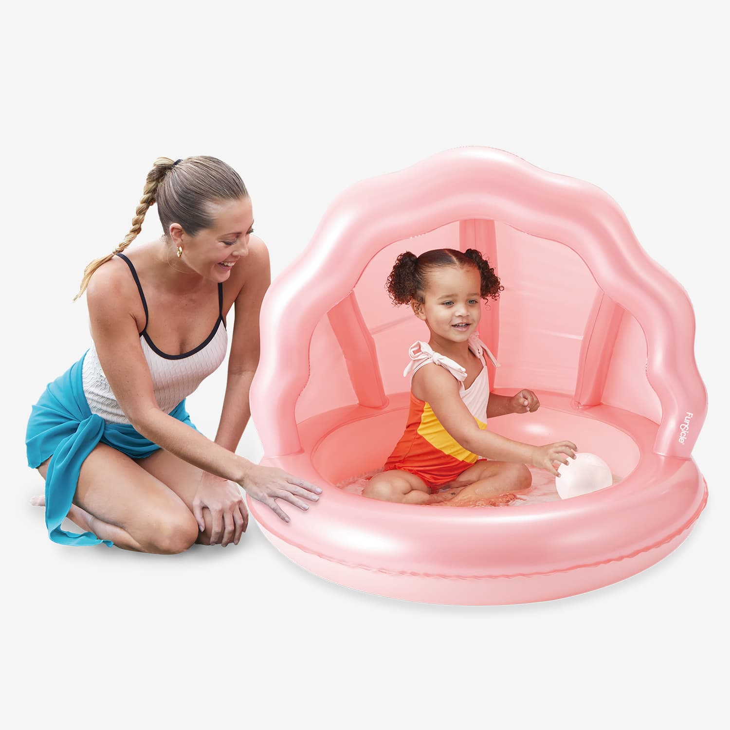 Woman and child playing in a pink inflatable shaded pool on a white background