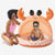 Woman and child playing in a crab-shaped inflatable pool on a white background