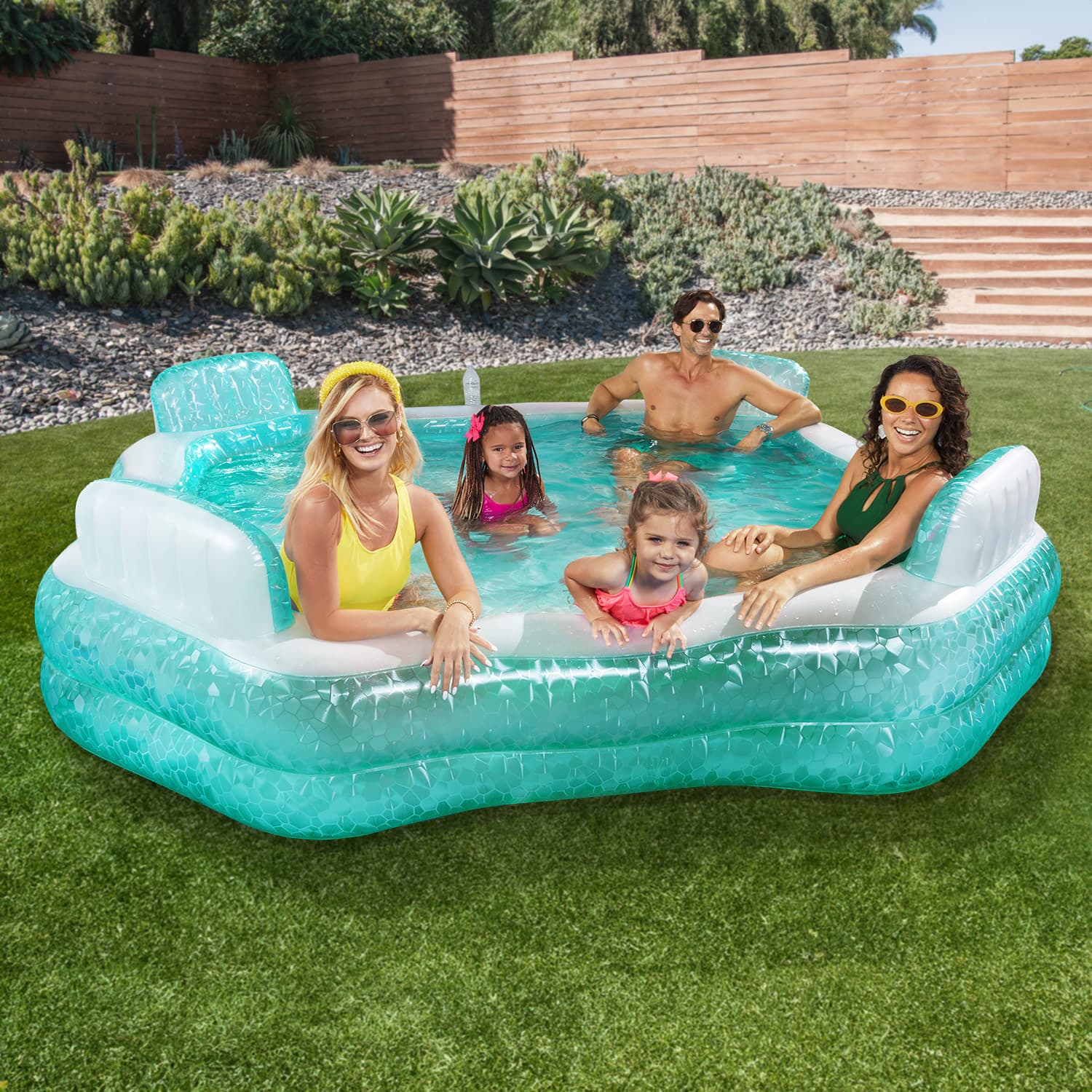 Funsicle Summer Escape Pool with models in the backyard