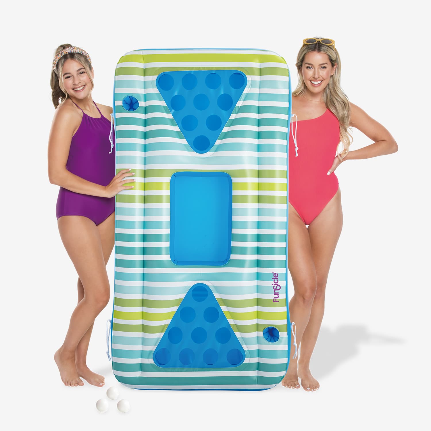 Two women holding a colorful inflatable pool float with striped pattern and blue triangles.