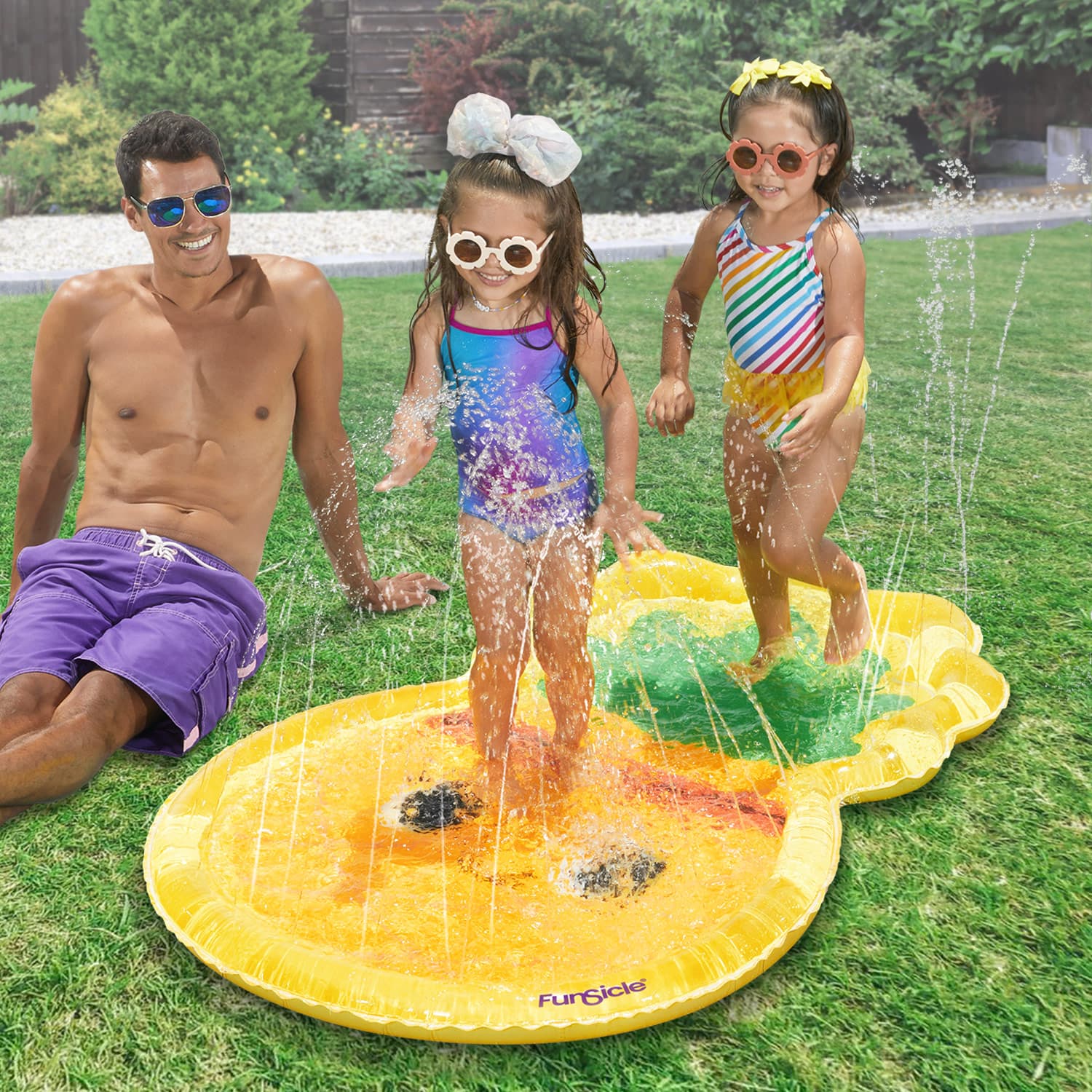 models with Funsicle Pineapple FunSpray Splash Mat in a garden