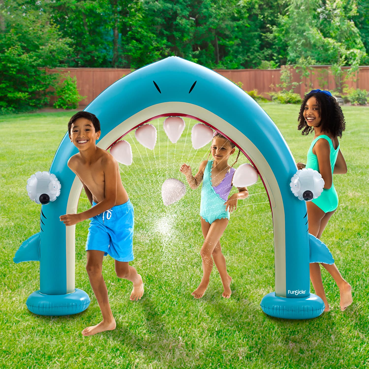 Funsicle Shark Jaws Sprinkler with models in the backyard