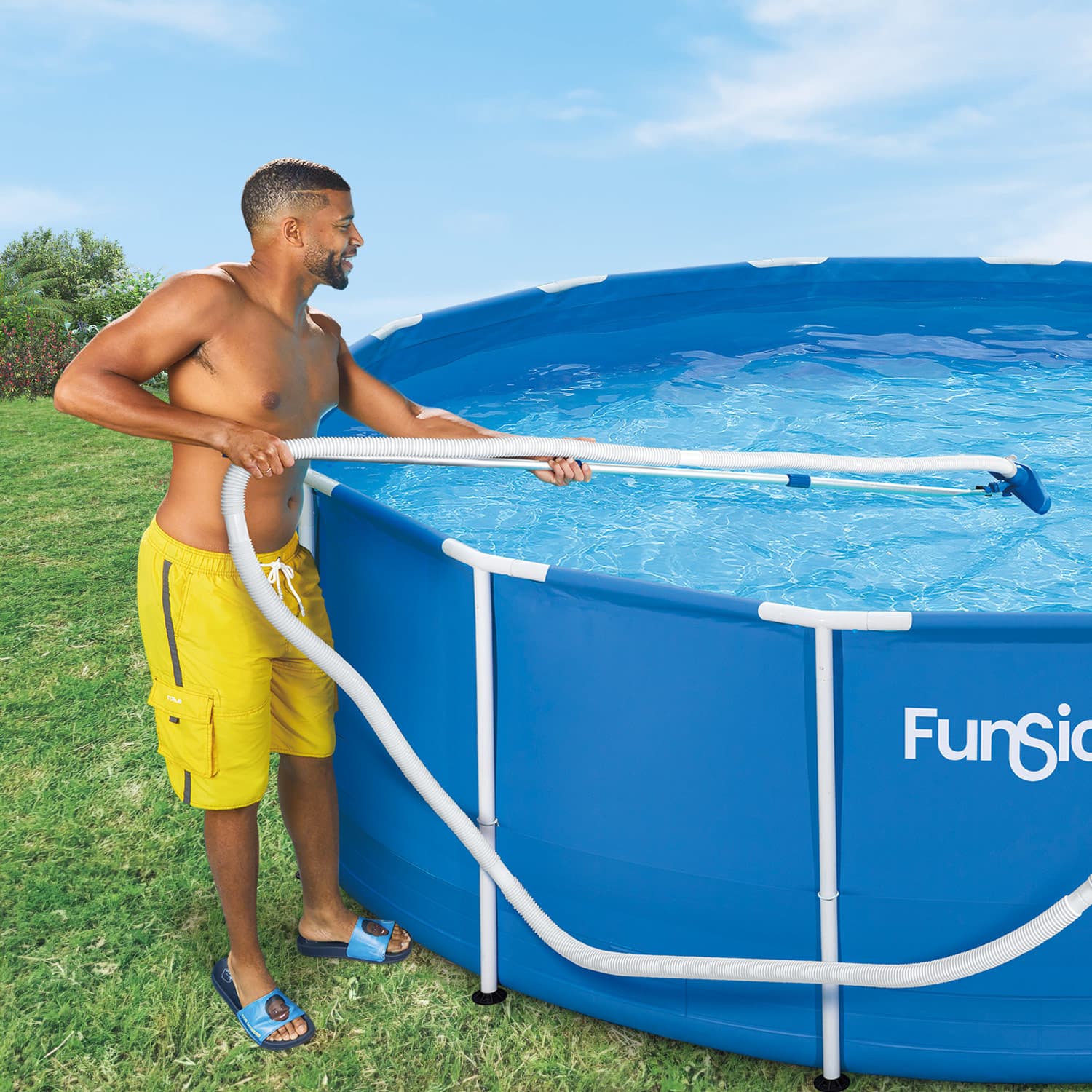 a man cleaning a blue pool on grass background