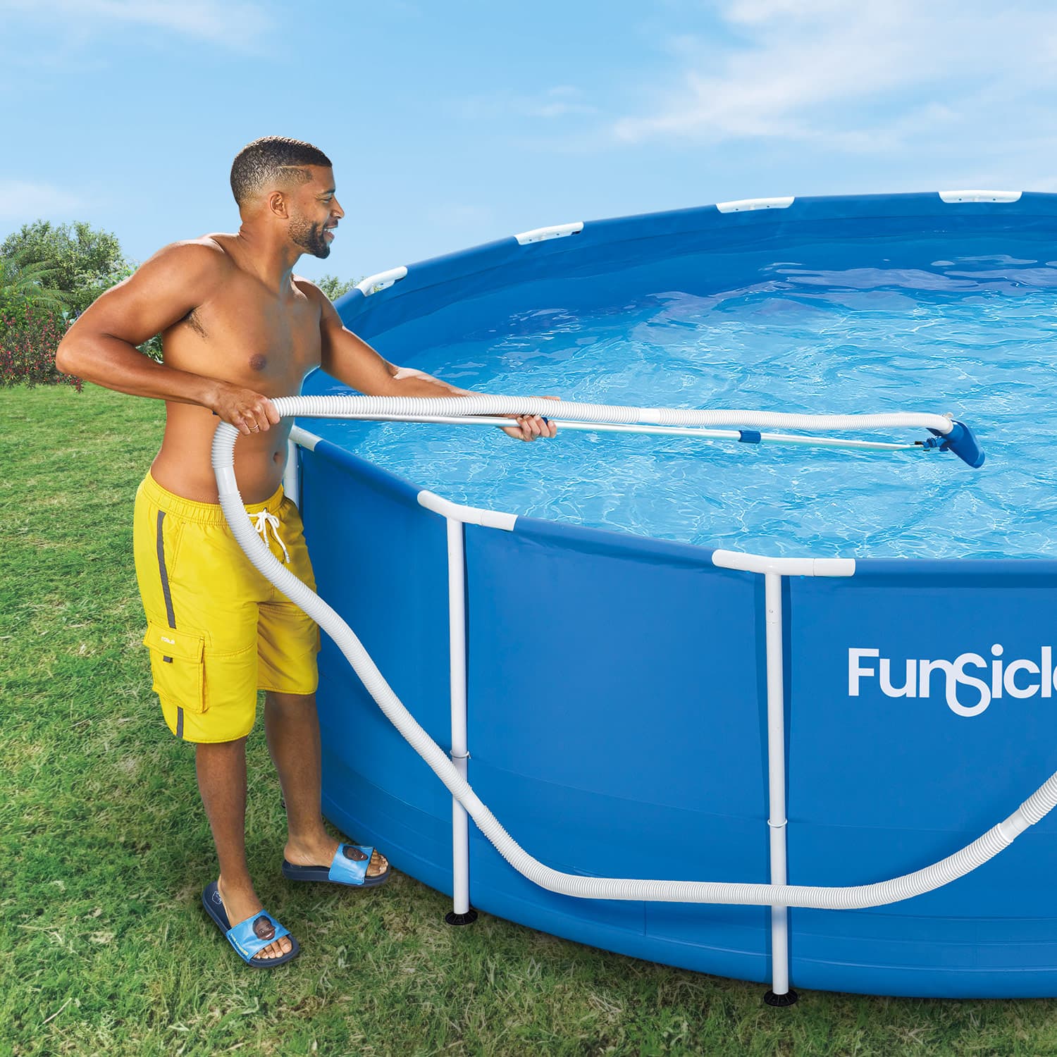 Man cleaning a blue above-ground pool with 'Funsicle' branding on a grassy lawn.